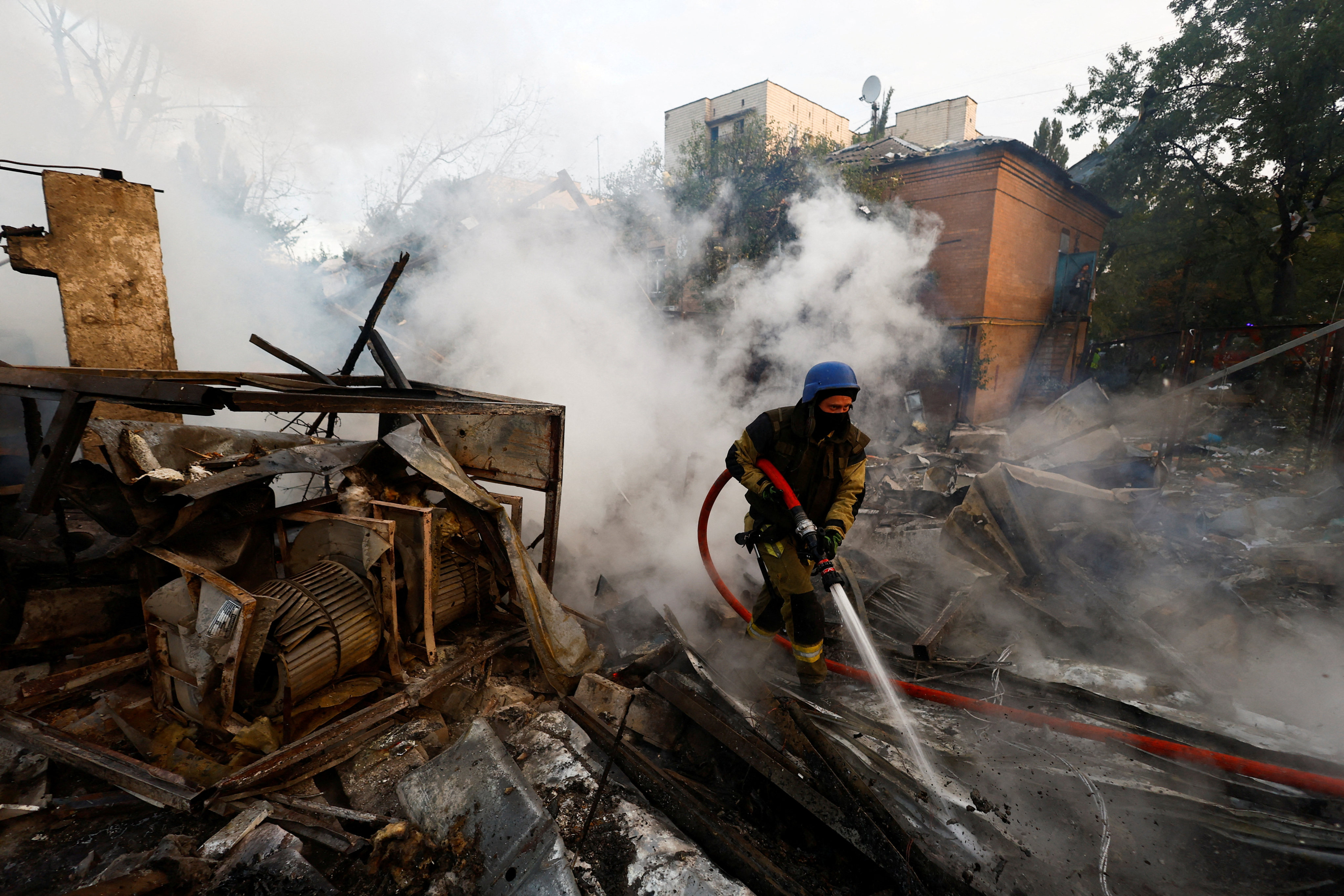 A firefighter at the scene of a Russian missile strike in Kyiv, Ukraine. Photo: Reuters