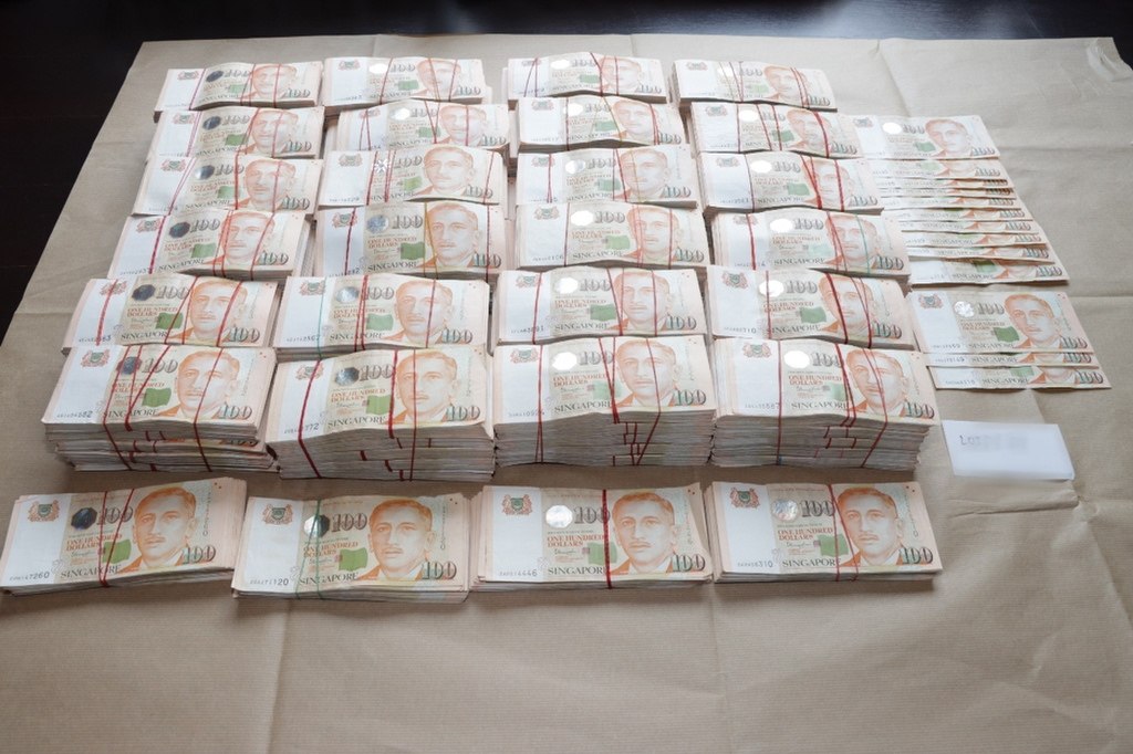 A photo released by Singapore police of bank notes seized  during an anti-money laundering raid in Singapore last month. Photo: EPA-EFE  