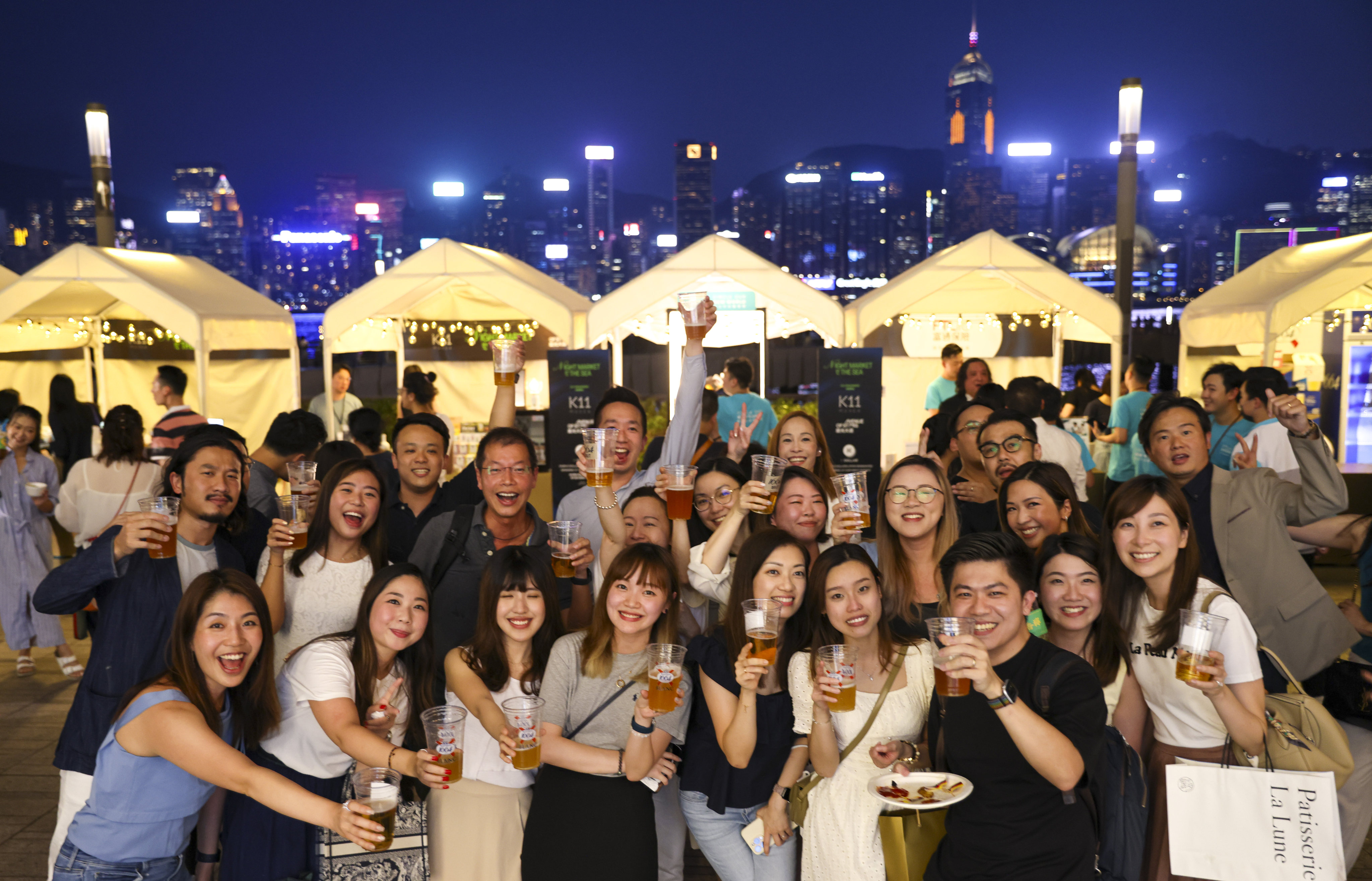 Happy visitors raise a glass at the Night Market by the Sea on Friday. Photo: Yik Yeung-man