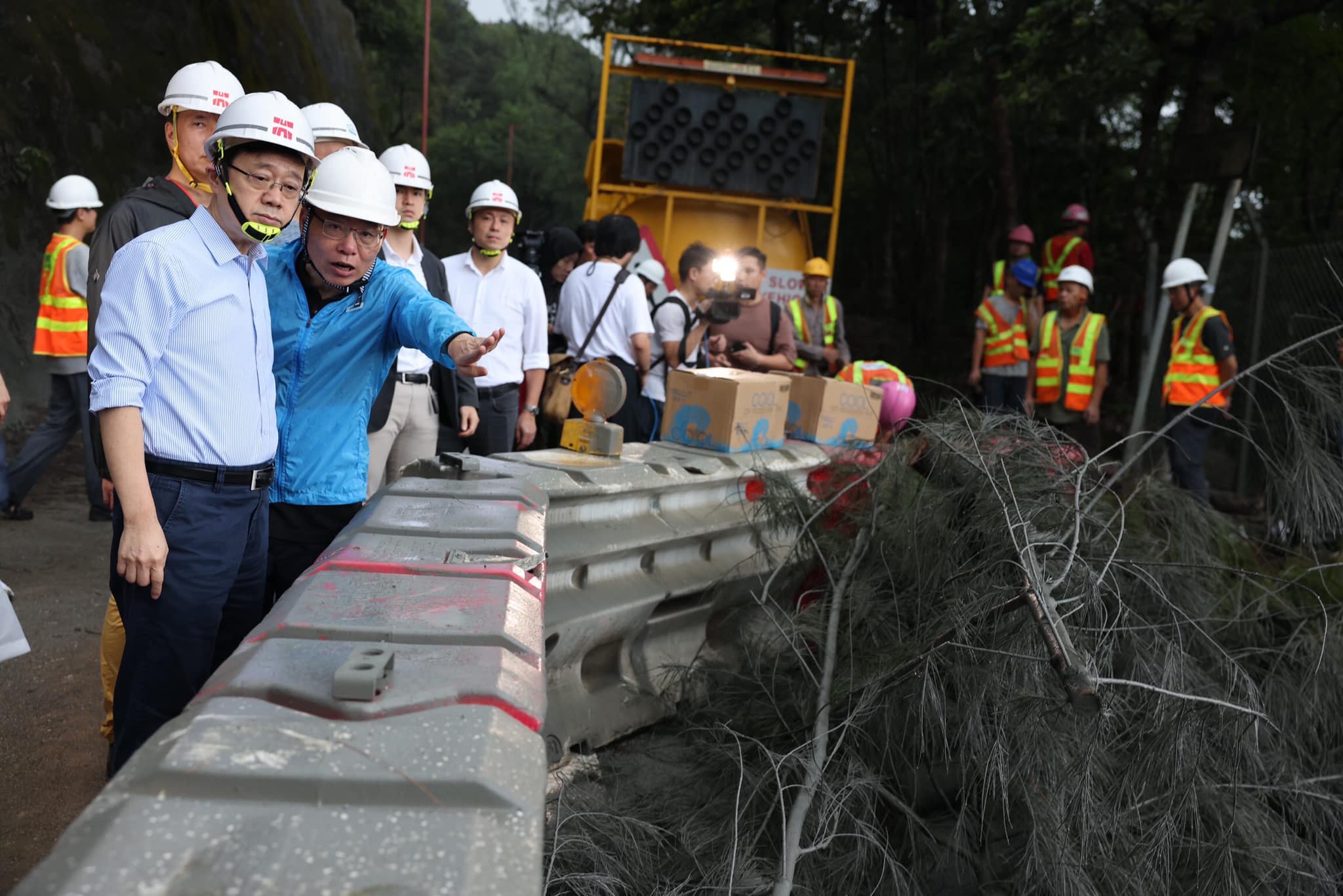 Chief Executive John Lee inspects a road blocked by a landslide in Shek O. Photo: Facebook