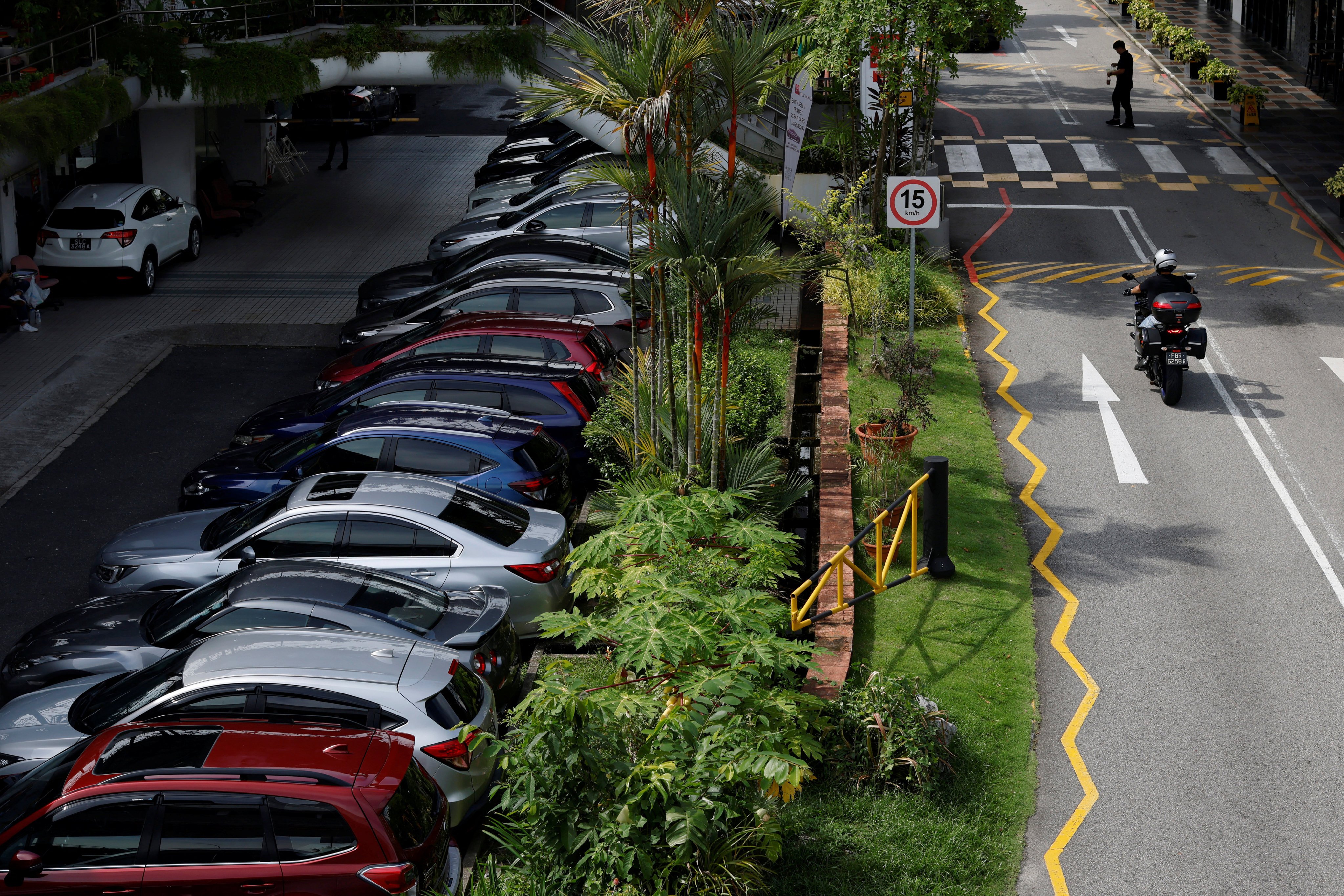Cars for sale are parked at used car dealerships in Singapore. Higher COE prices continue a trend that has seen such values exceeding S$100,000 in the last 12 months. Photo: Reuters