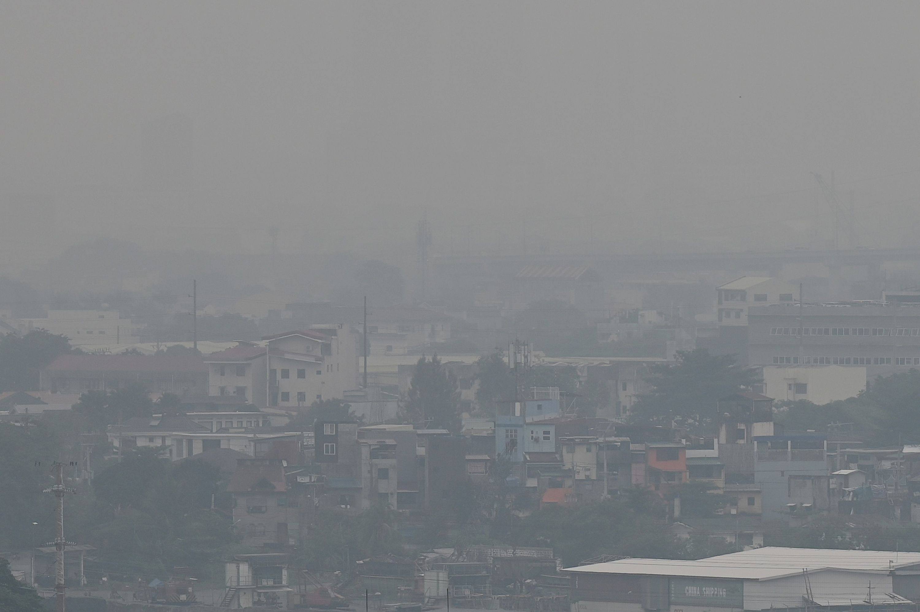 The Manila skyline is seen shrouded in smog. Photo: AFP