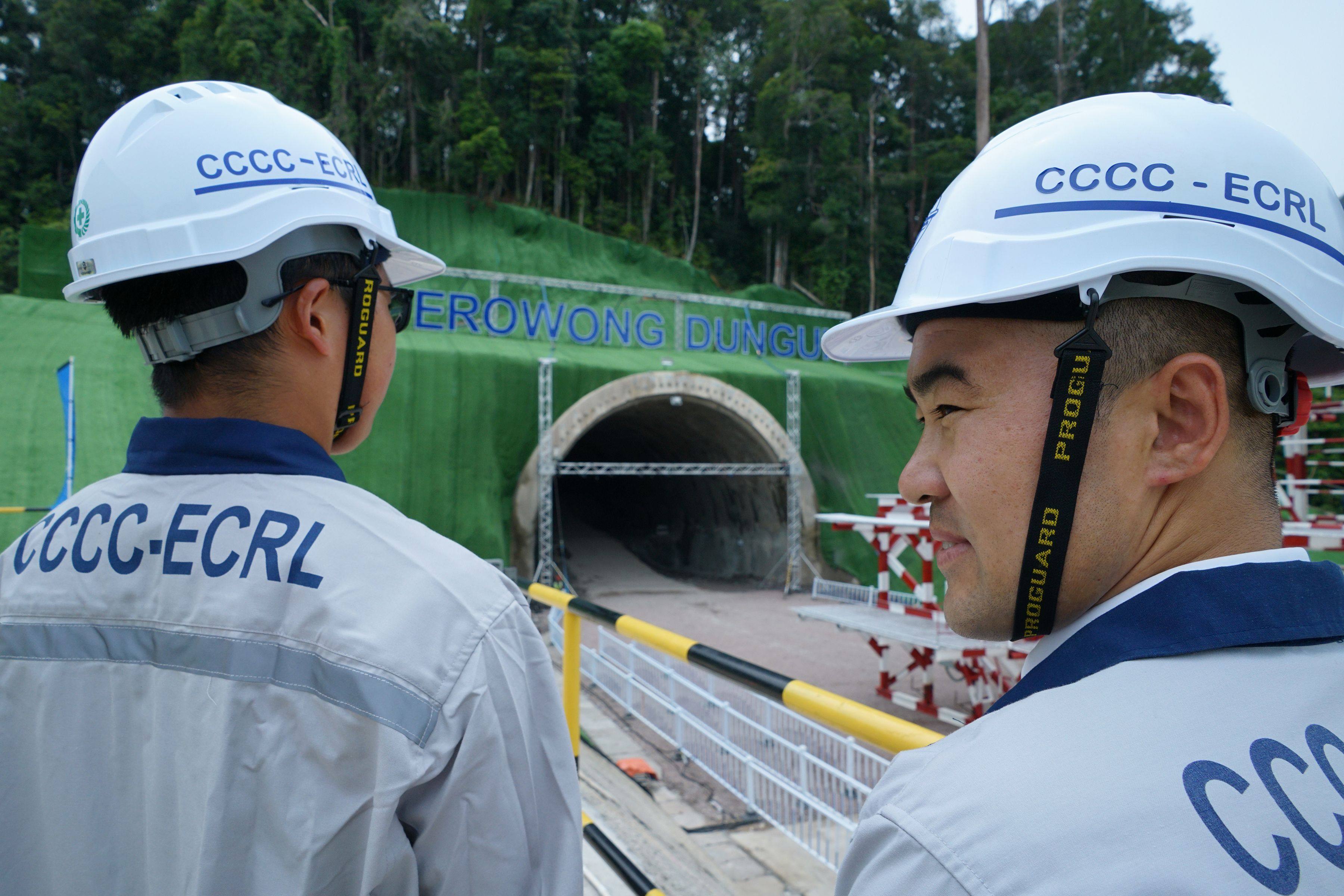 Chinese workers stand near the entrance of a tunnel being constructed for Malaysia’s East Coast Rail Link in 2019. Imported workers are often preferred for belt and road projects over local hires. Photo: AFP
