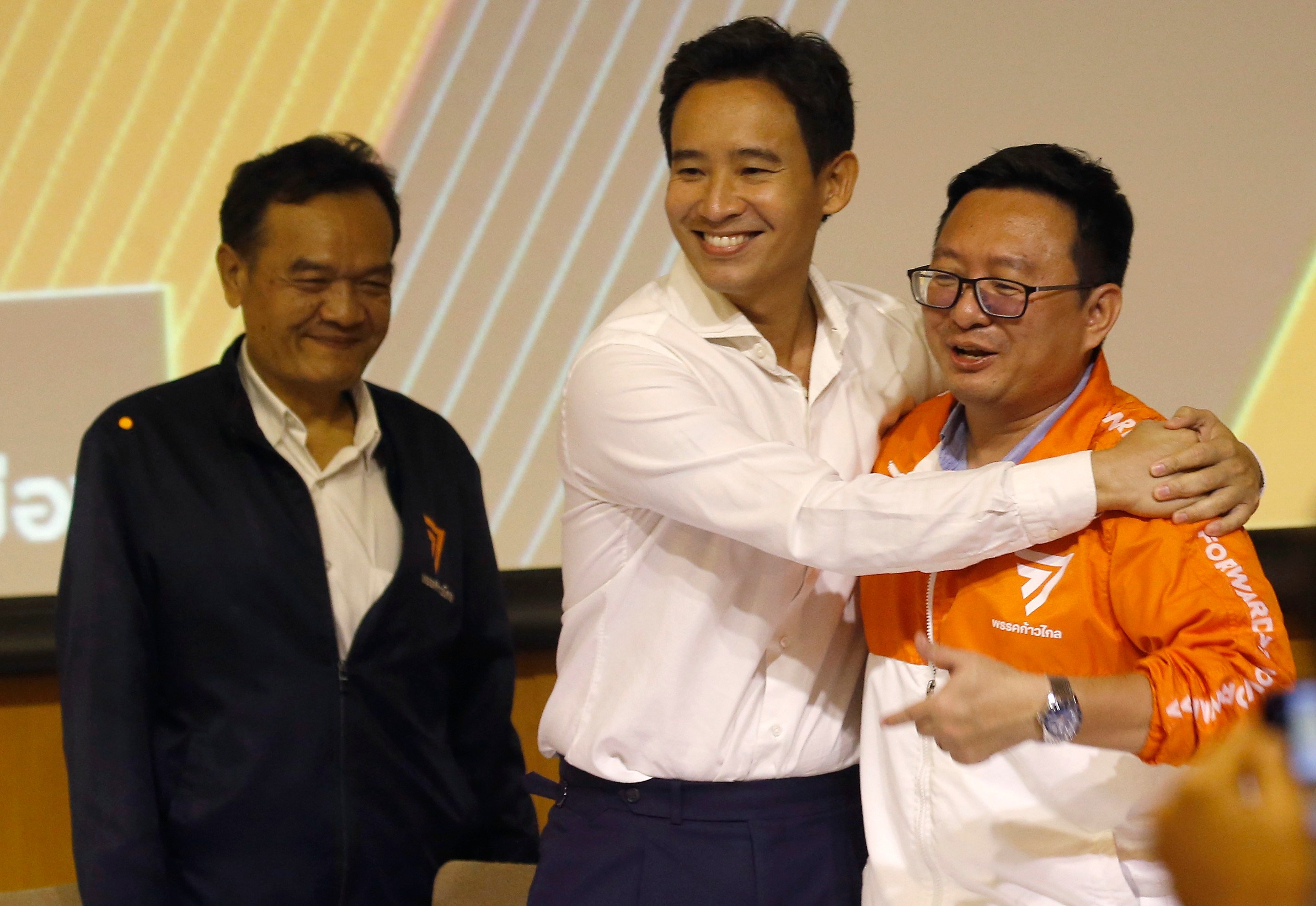The new leader of the Move Forward Party, Chaithawat Tulathon, right, is congratulated by the chairman of party advisory committee Pita Limjaroenrat after he won a vote for the new party leadership during the party’s meeting in Bangkok. Photo: EPA-EFE