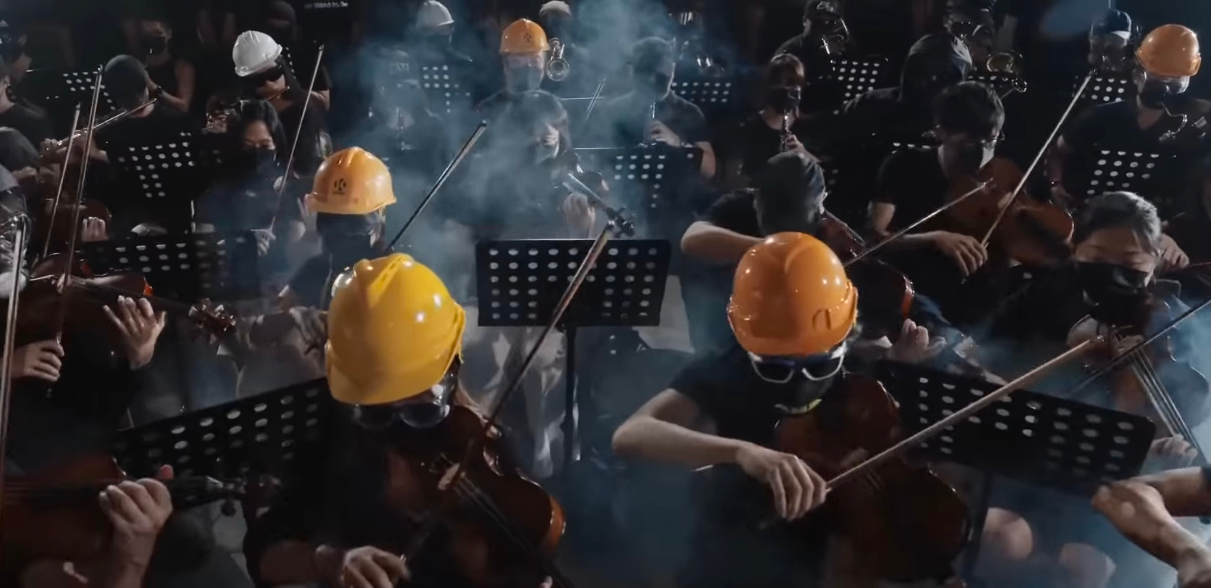 An orchestra in helmets and gas masks performs “Glory to Hong Kong”, which became the anthem of the 2019 protests. Photo: YouTube