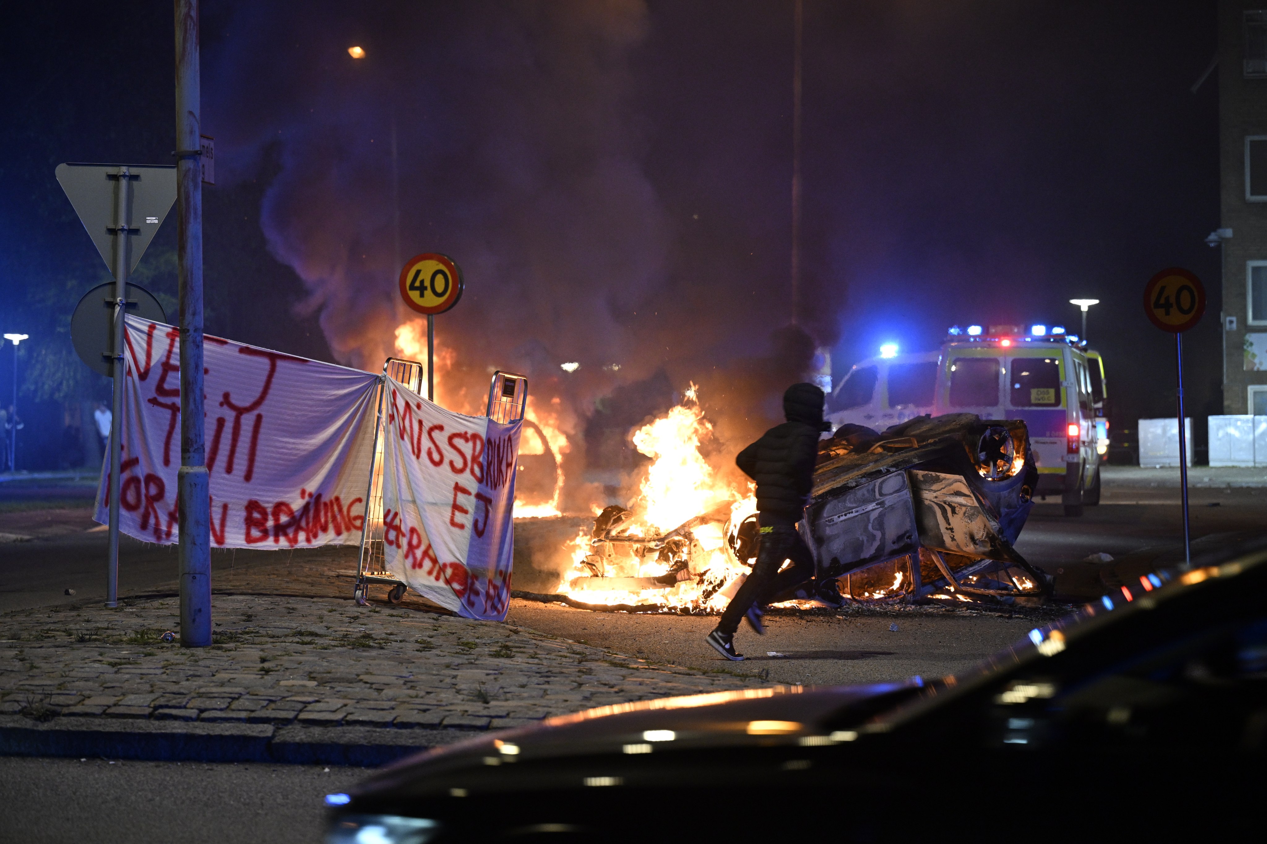 Flames and a banner reading ‘No to Koran burning. Do not abuse freedom of expression’ in Malmo, Sweden earlier this month. Photo: EPA-EFE