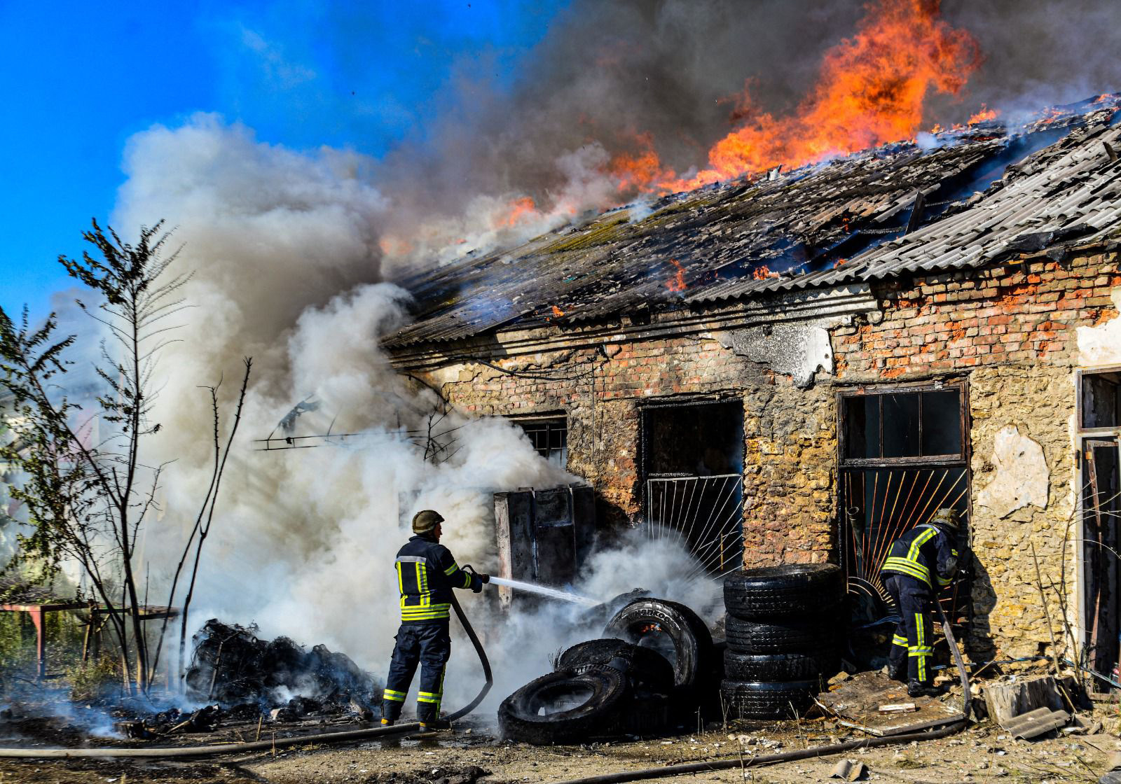 Ukrainian firefighters extinguishing a fire after shelling in the Kherson region. Photo: AFP