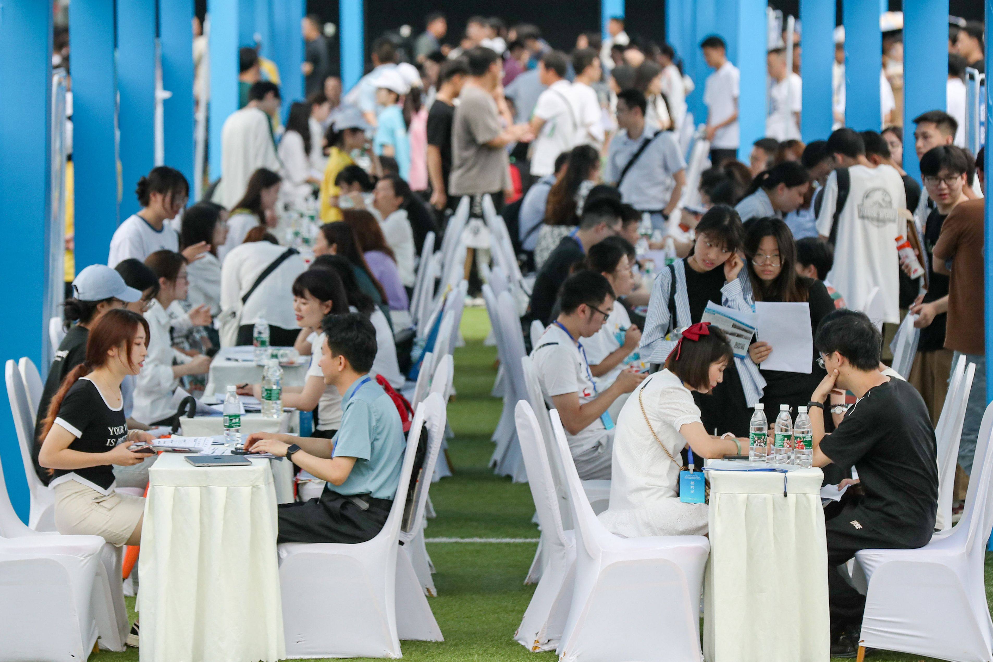 University graduates and youths attending a job fair in Yibin of China’s southwestern Sichuan province on June 14, 2023. College students will have another source of stress as universities plan tuition fee raises for the fall. Photo: CNS/AFP
