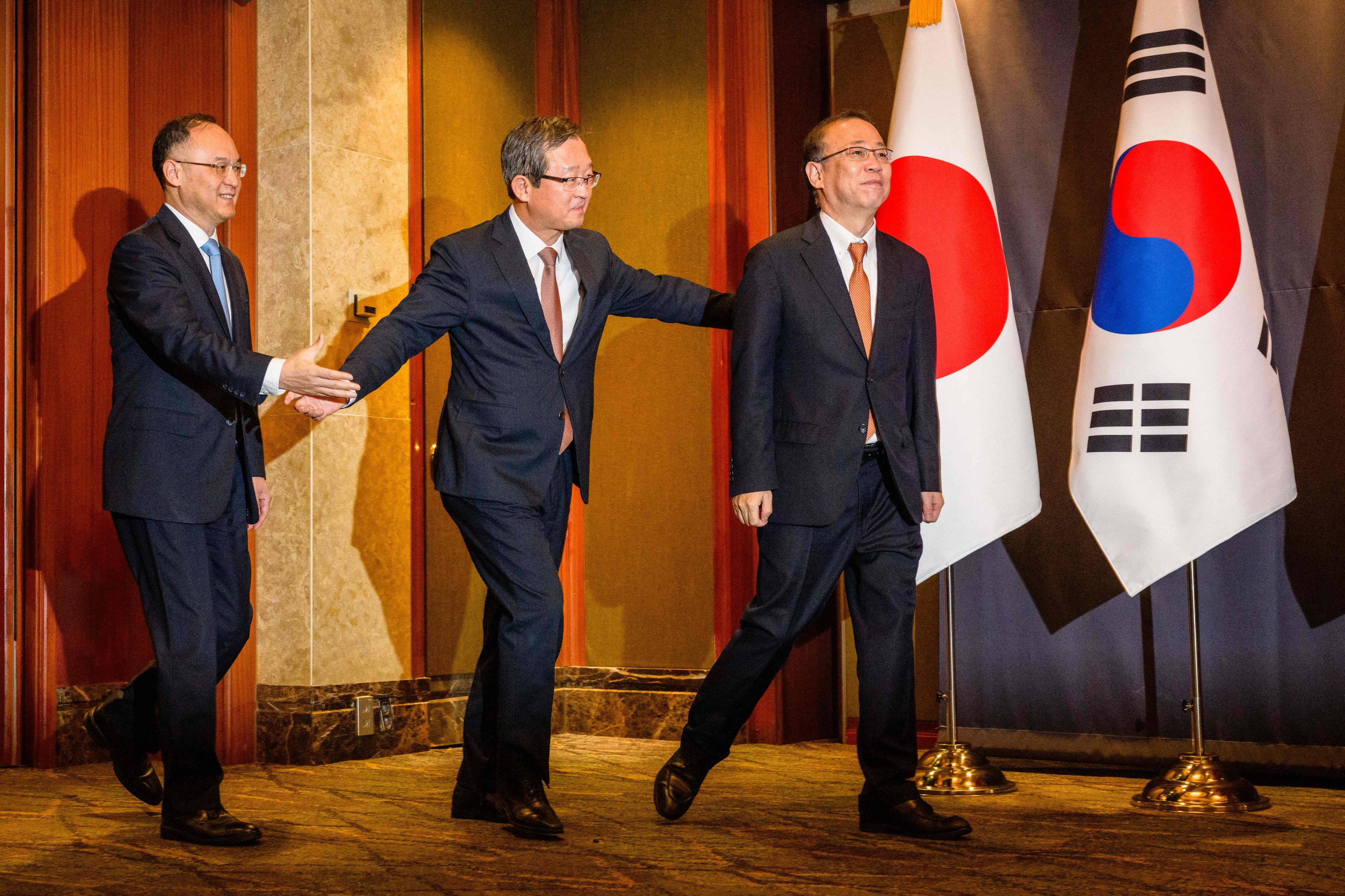 (From left) Nong Rong, China’s assistant minister of foreign affairs, and his South Korean and Japanese counterparts, Chung Byung-won and Takehiro Funakoshi, arrive for a meeting in Seoul on Tuesday. Photo: AFP