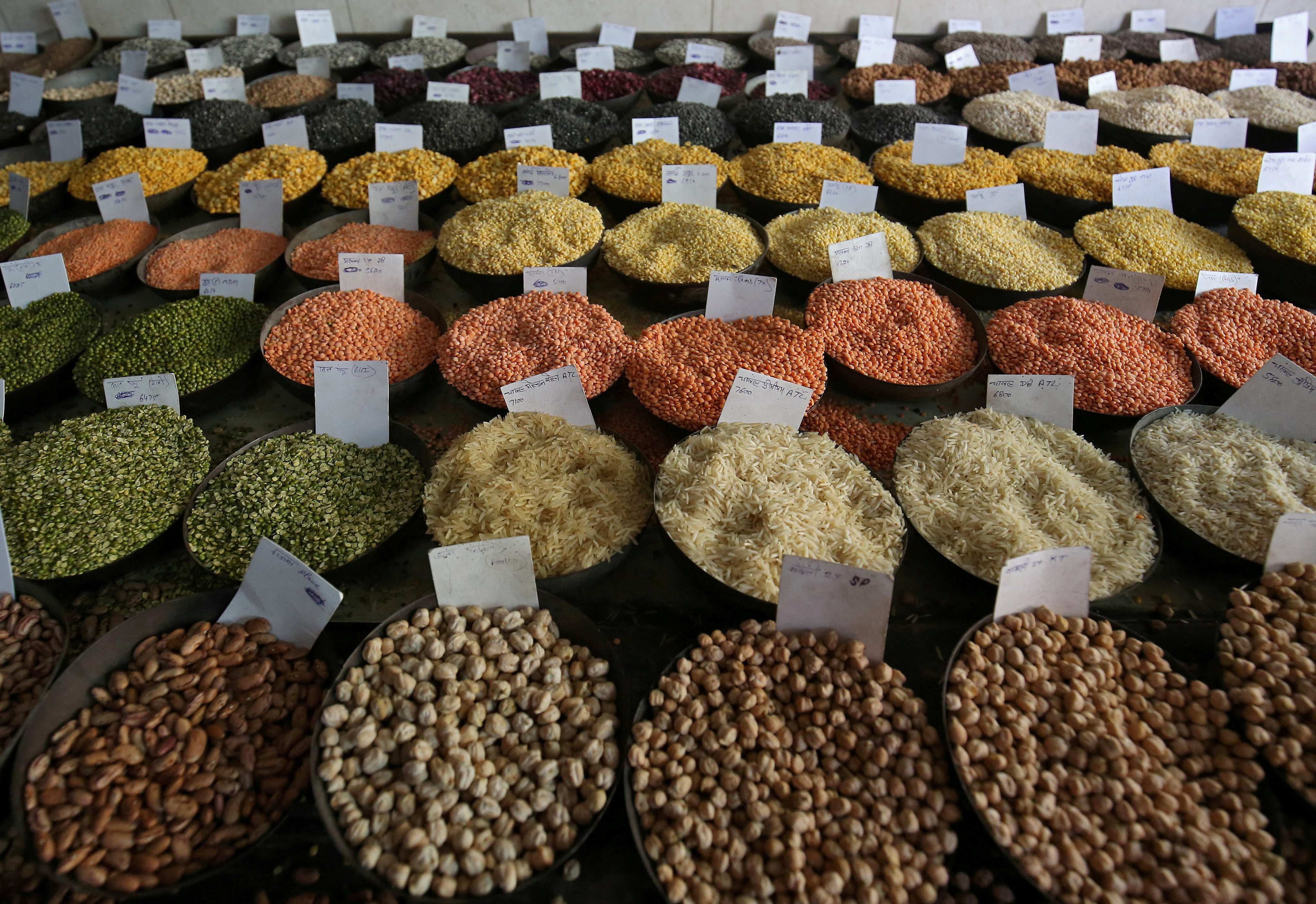 Price tags are displayed on bags of rice and lentils at a wholesale market in New Delhi. Photo: Reuters
