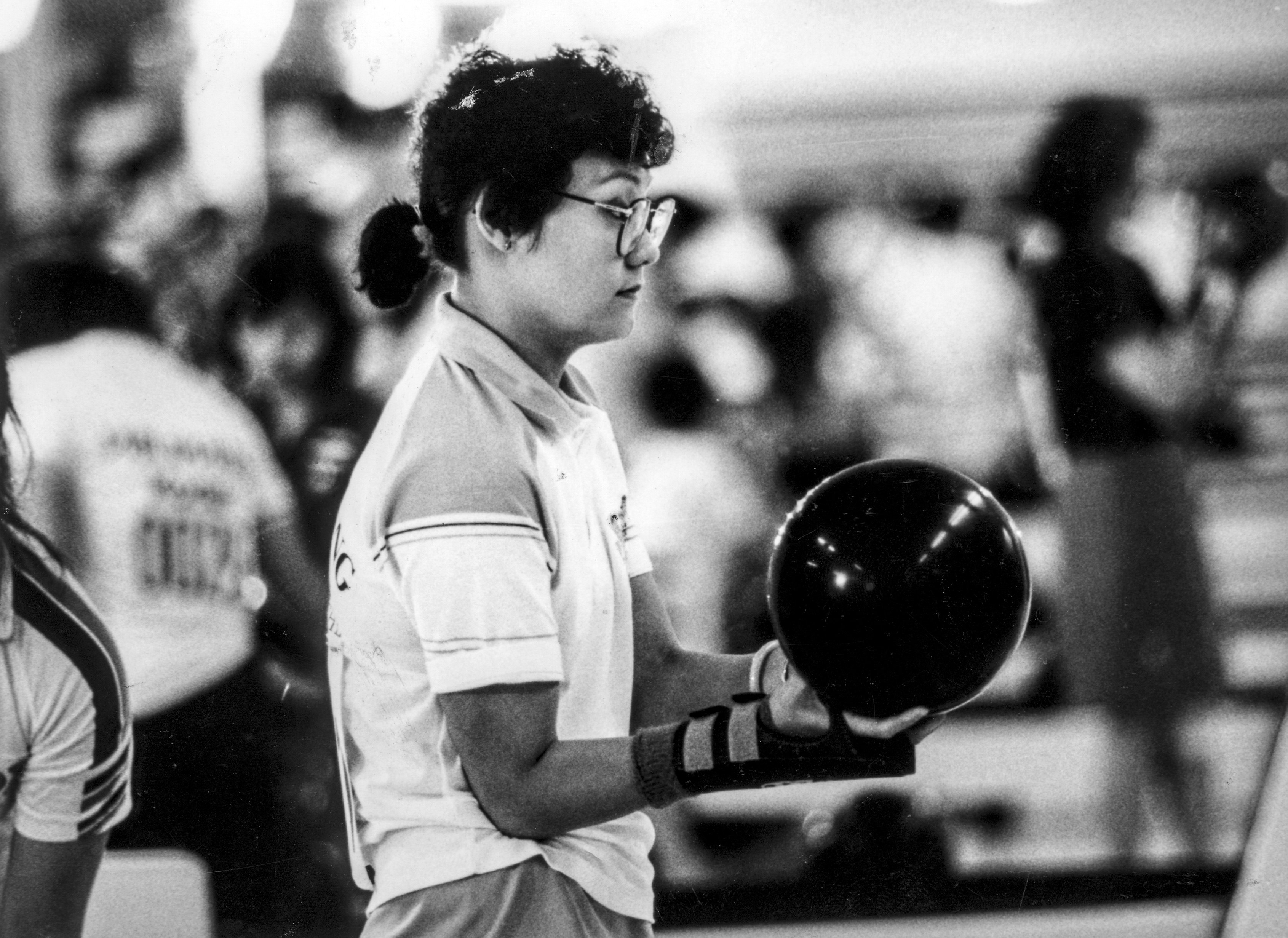 Table tennis player strikes bowling pins with ping-pong balls