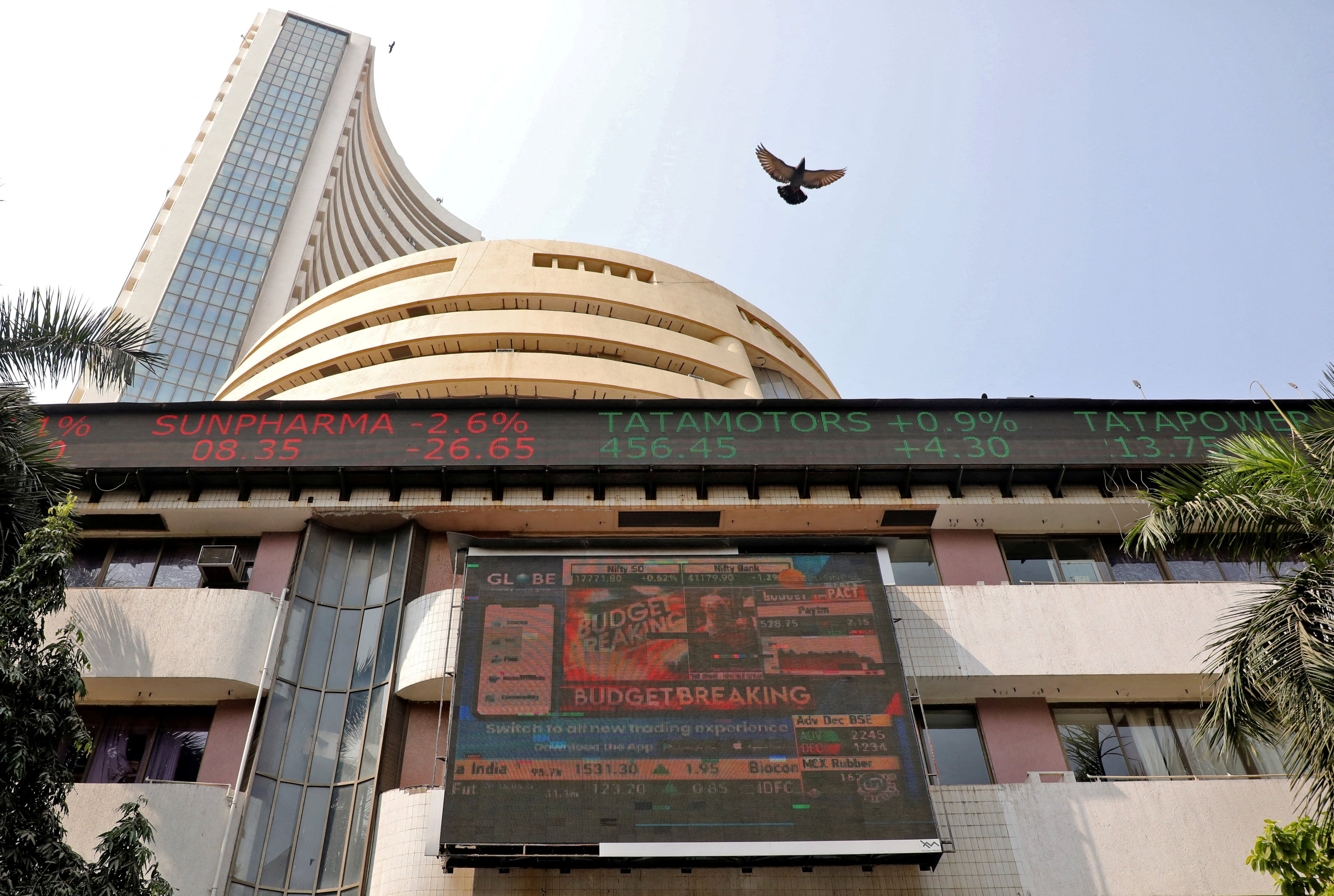 A bird flies over a screen displaying stock data outside the Bombay Stock Exchange building in Mumbai on February 1. While global investors continue to sell down their holdings of Chinese stocks, they have purchased US$15.8 billion of Indian equities since the start of this year. Photo: Reuters