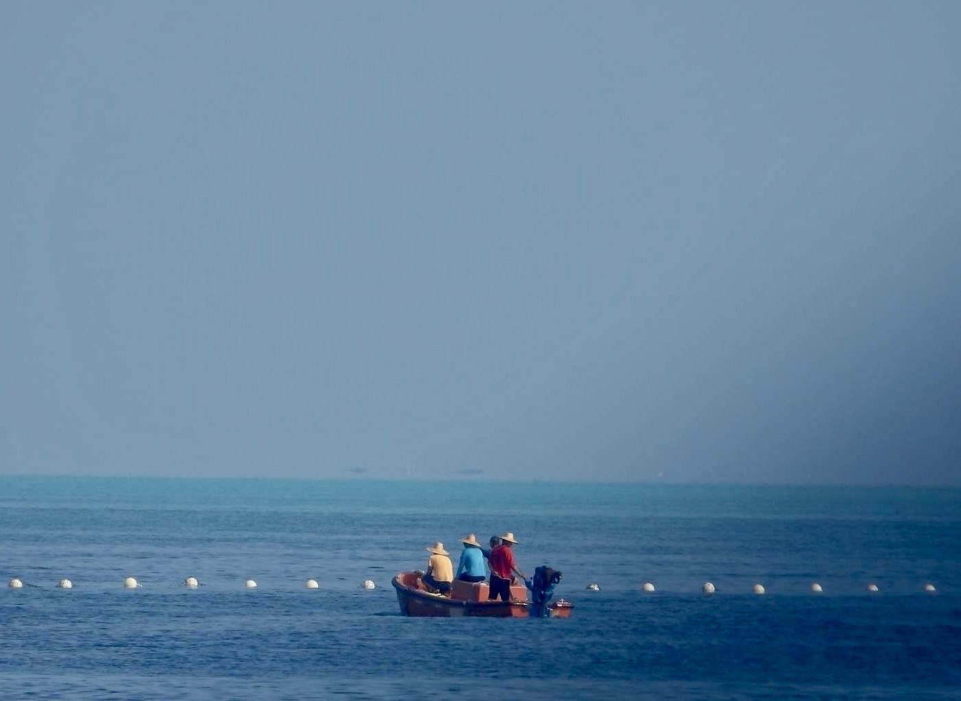 Chinese coastguard boats patrolling next to a floating barrier at the vicinity of Scarborough Shoal in the disputed South China Sea on September 20. Photo: EPA-EFE/PCG