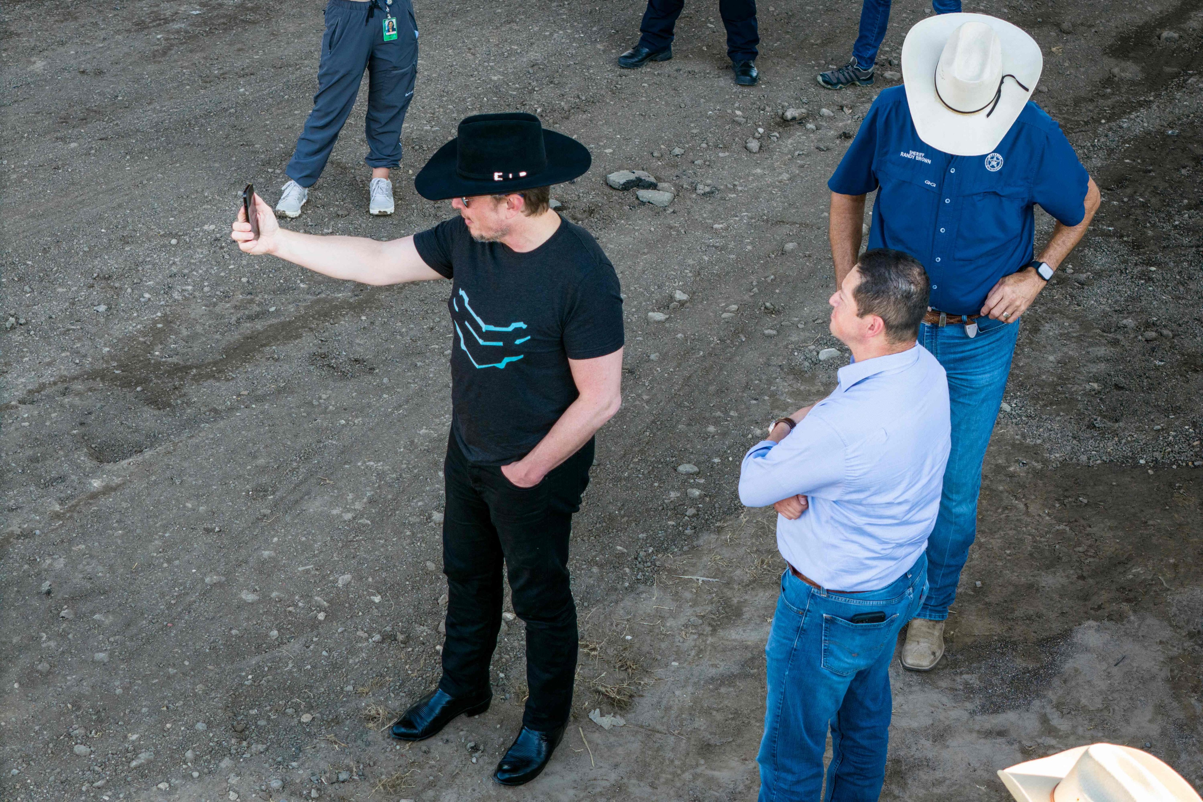 Elon Musk, wearing a black cowboy hat, livestreaming while visiting the Texas-Mexico border. Photo: AFP