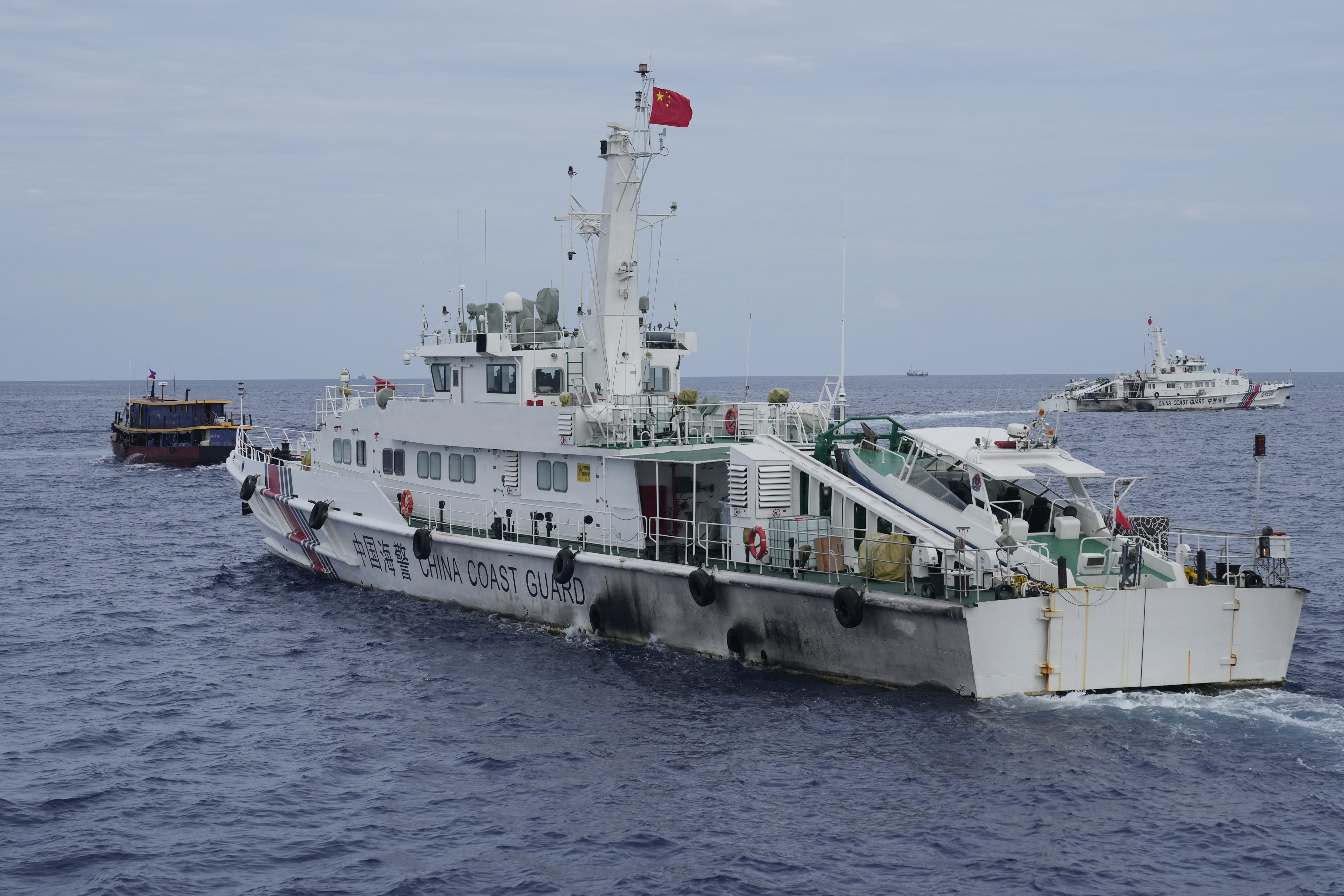A Chinese coastguard ship tries to block the way of a Philippine supply boat, left, as it heads towards Second Thomas Shoal, on August 22. Photo: AP