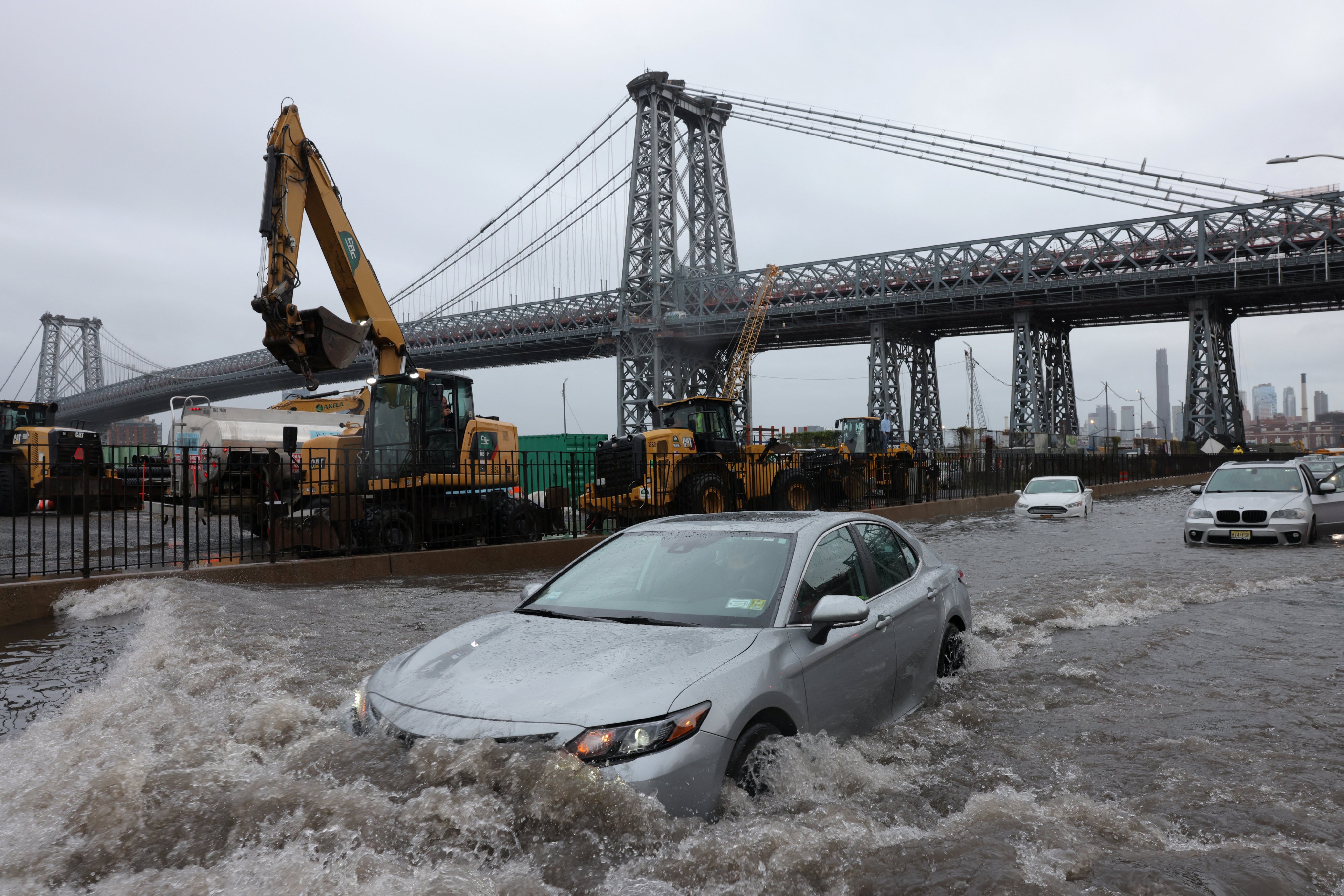 A motorist drives through a flooded street after heavy rains in New York on Friday. Photo: Reuters