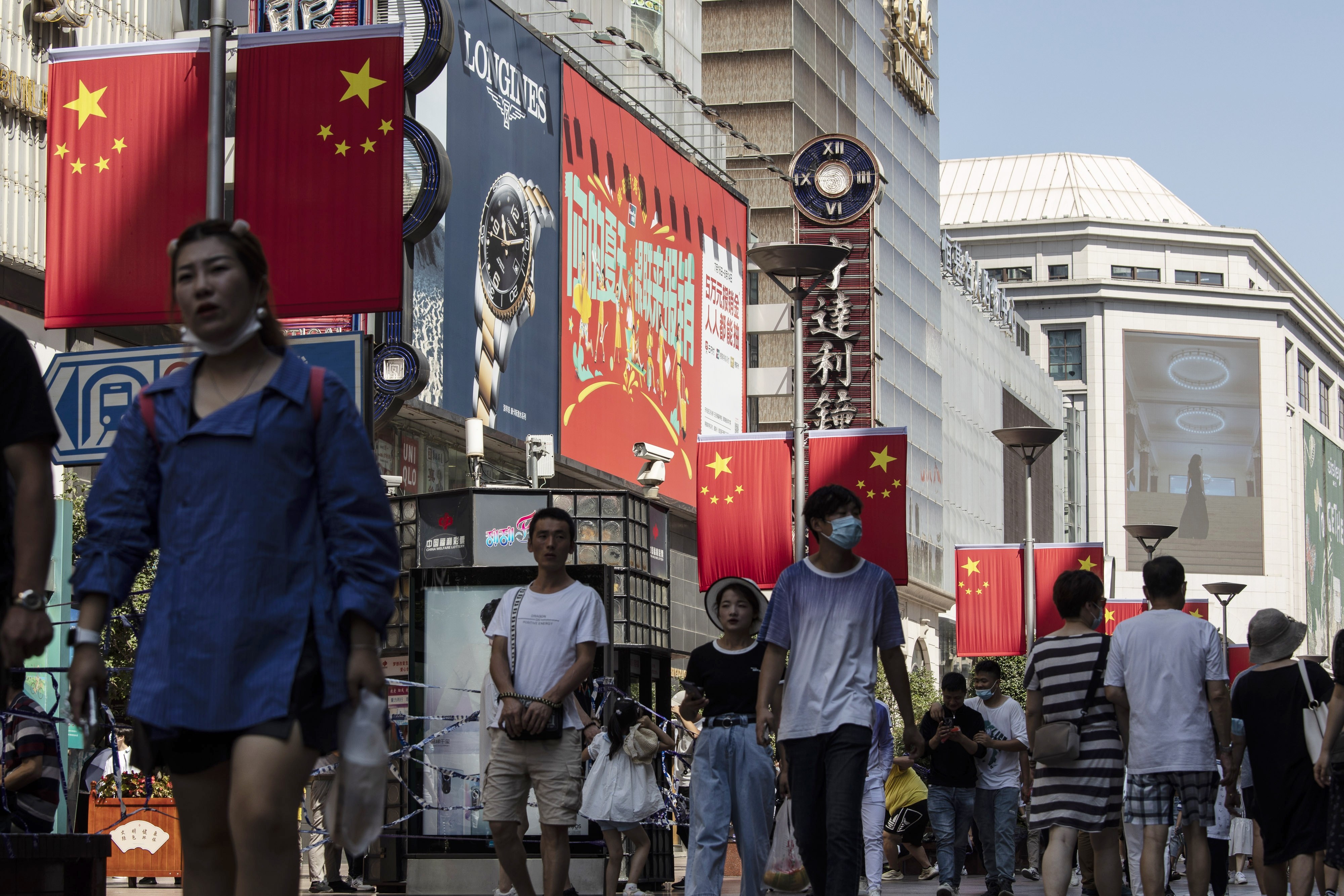Shoppers and visitors walk along Nanjing Road East in Shanghai during golden week in 2021. Photo: Bloomberg