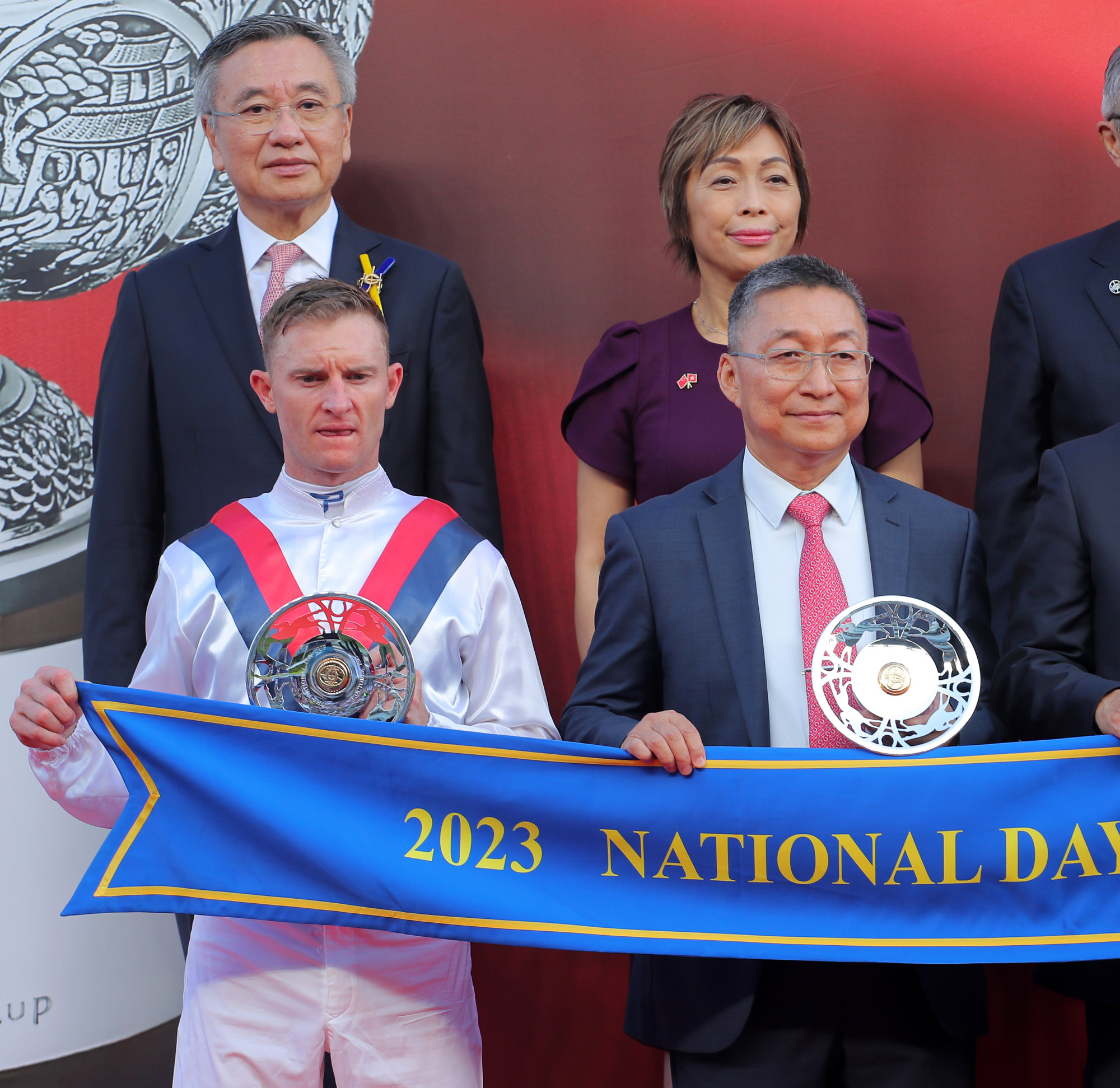 Zac Purton and Francis Lui receive their Group Three National Day Cup (1,000m) trophies.