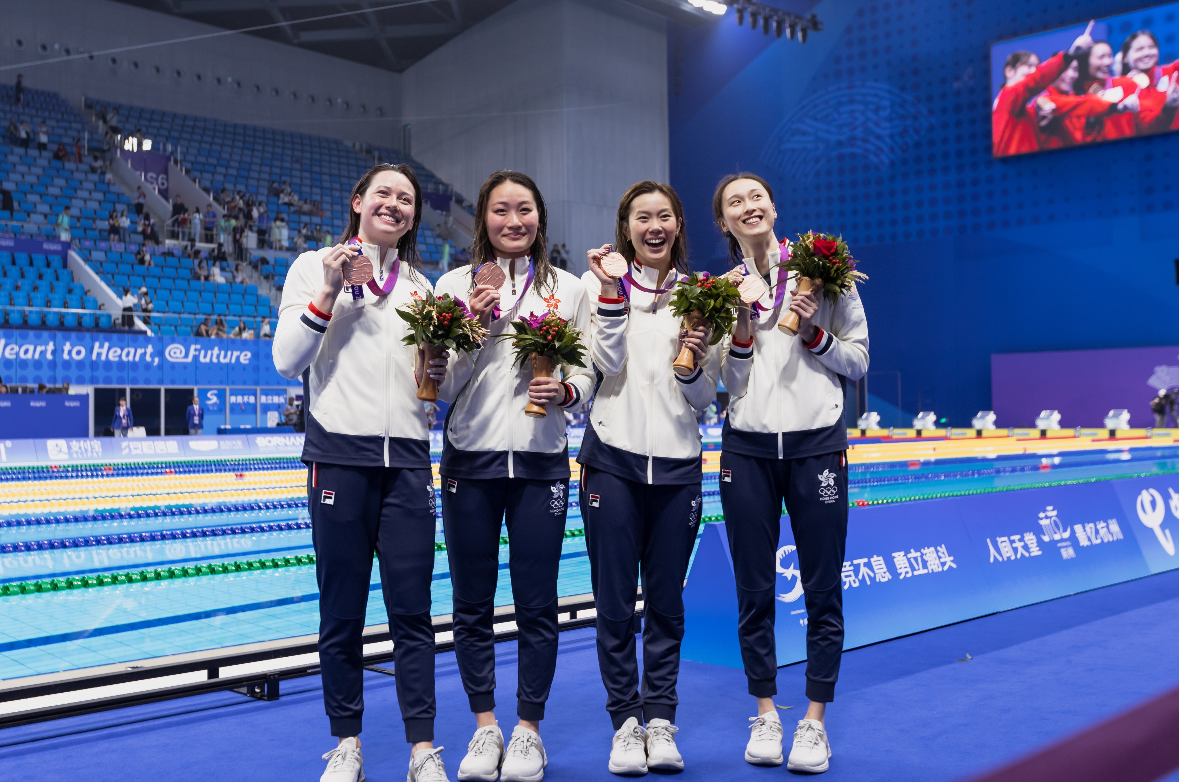 Siobhan Haughey (far left) picks up her sixth medal, a medley relay bronze alongside (from left) Natalie Kan Cheuk-tung, Stephanie Au Hoi-shun and Tam Hoi-lam. Photo: EPA-EFE