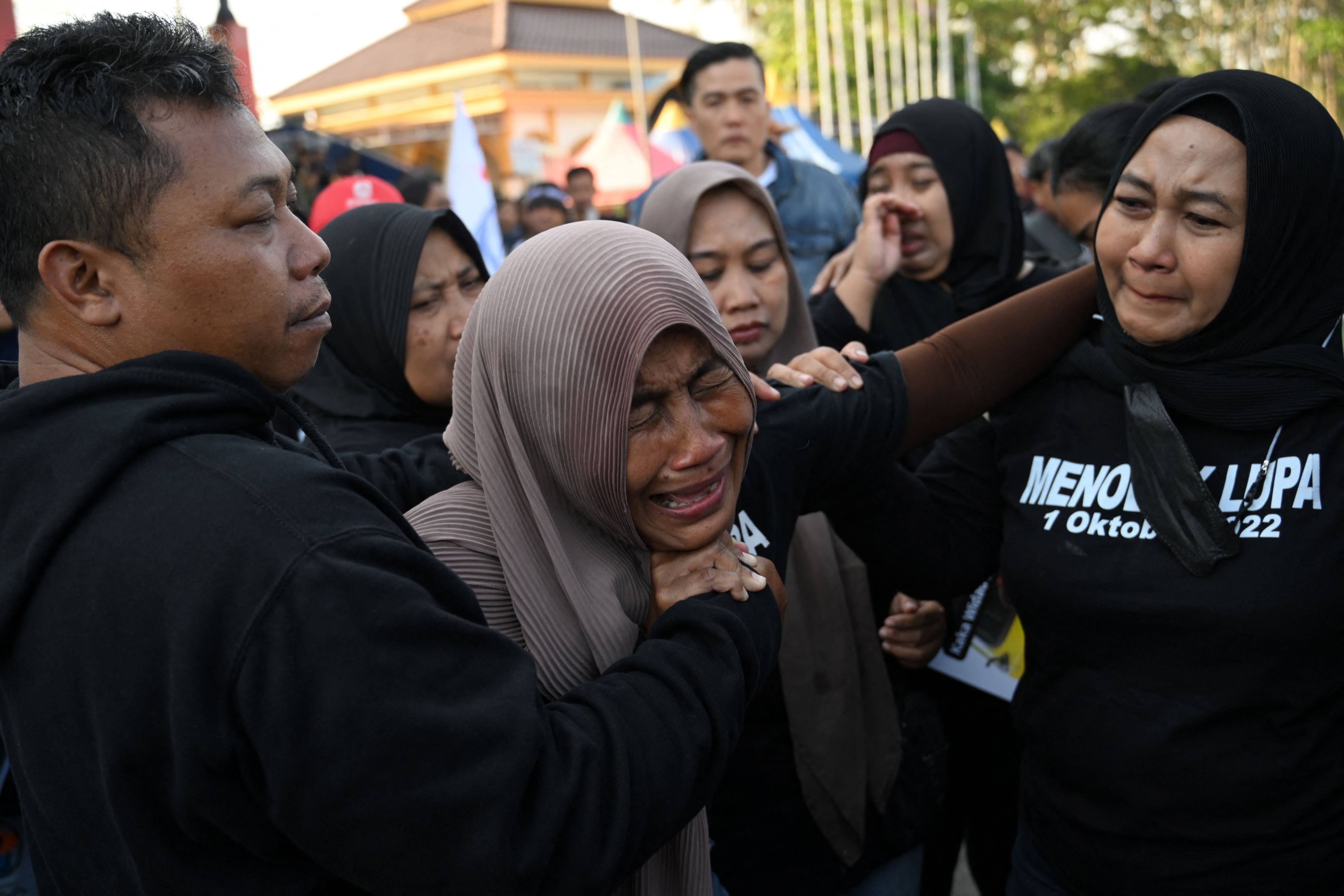 Family members mourn victims at a memorial service on Sunday on the first anniversary of the October 2022 stampede that killed 135 people at the Kanjuruhan football stadium in Malang, East Java, Indonesia. Photo: AFP