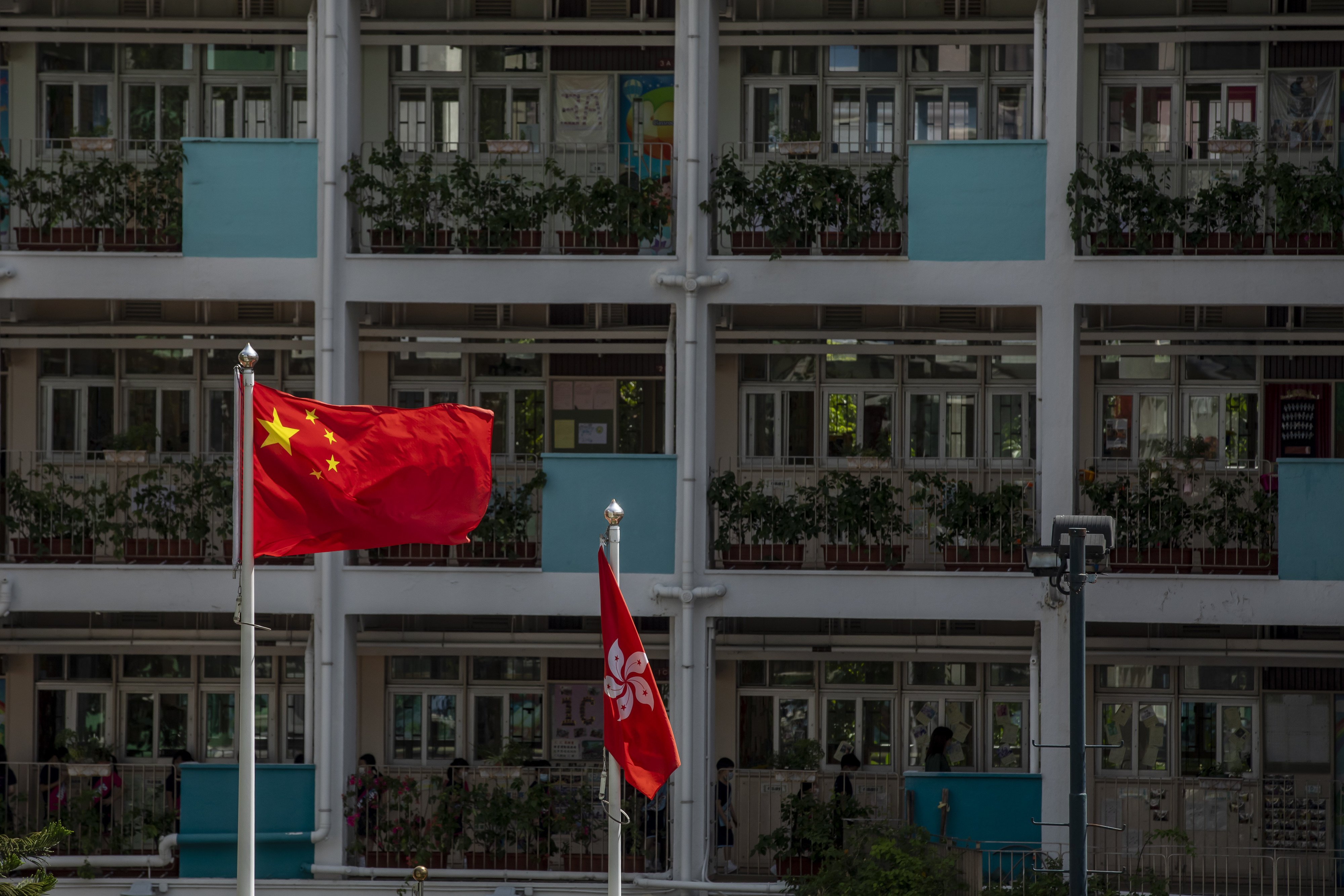 The flags of China and Hong Kong are flown in a school in Hong Kong in 2020. Photo: Bloomberg 