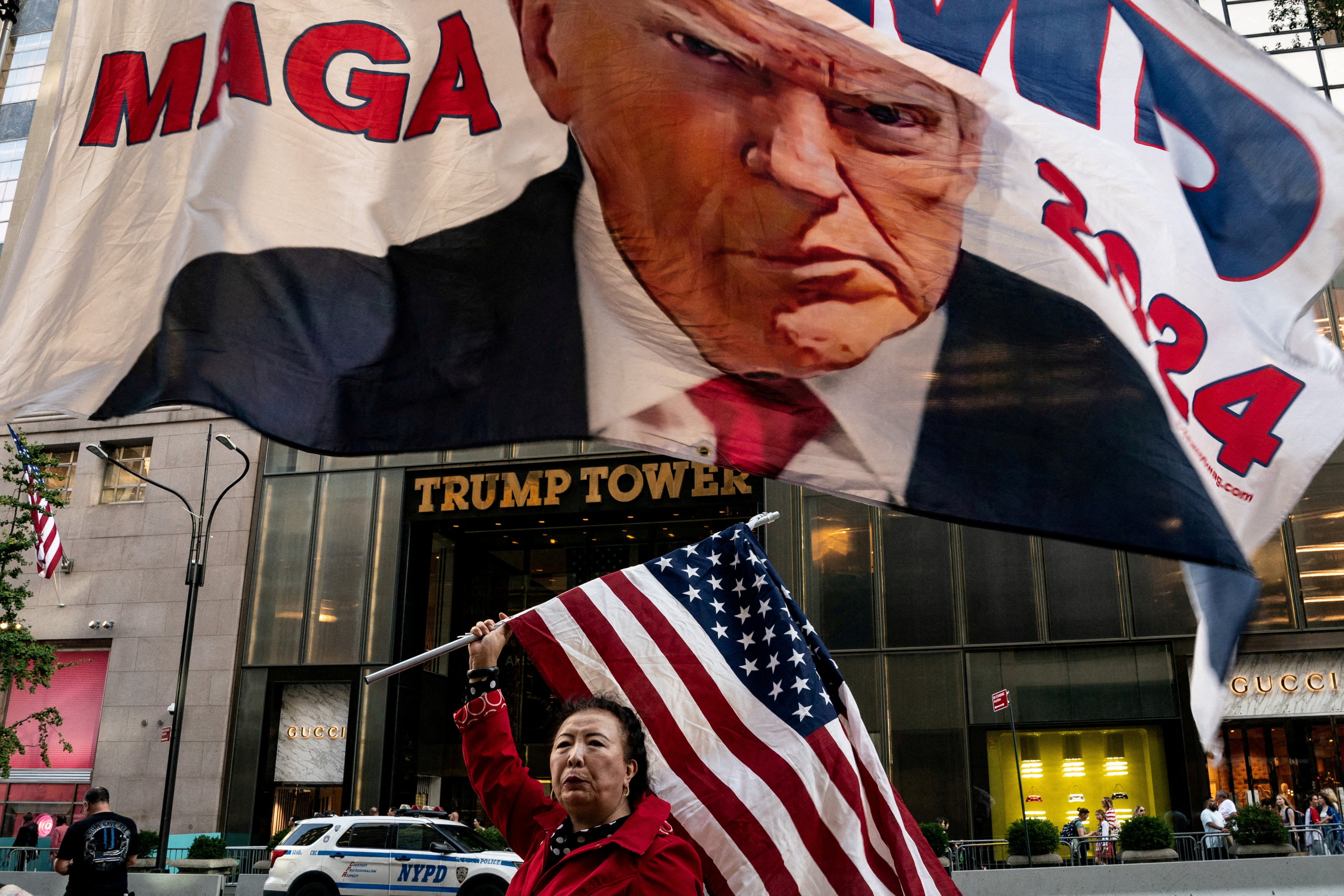 A supporter of former US President Donald Trump holds up a national flag at Trump Tower in New York City, on October 1. Trump’s most loyal supporters are looking to create as much chaos in America as the man they adore. Photo: Reuters