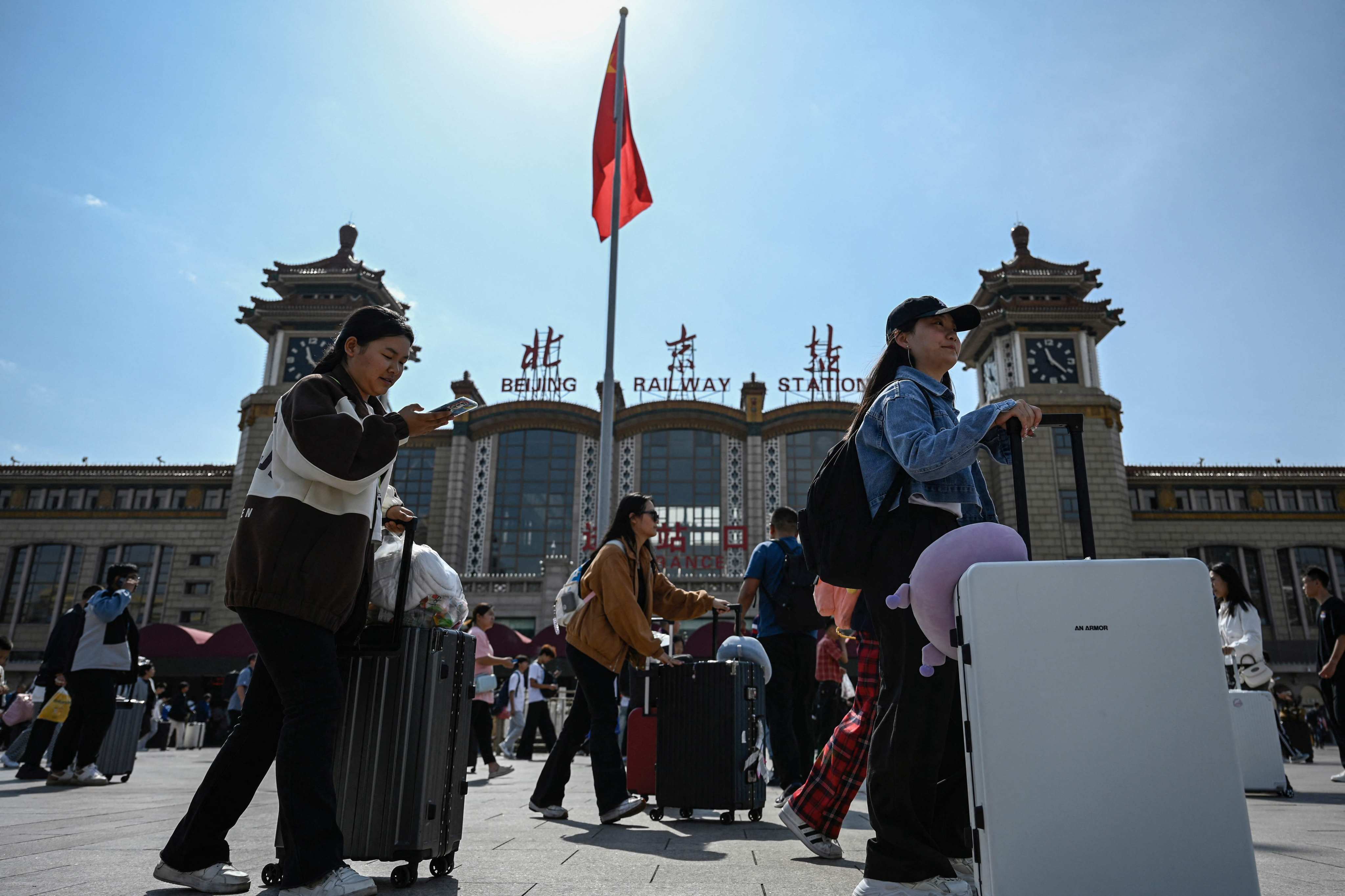 Passengers arrive at Beijing railway station on the first day of the holiday on Friday. Photo: AFP