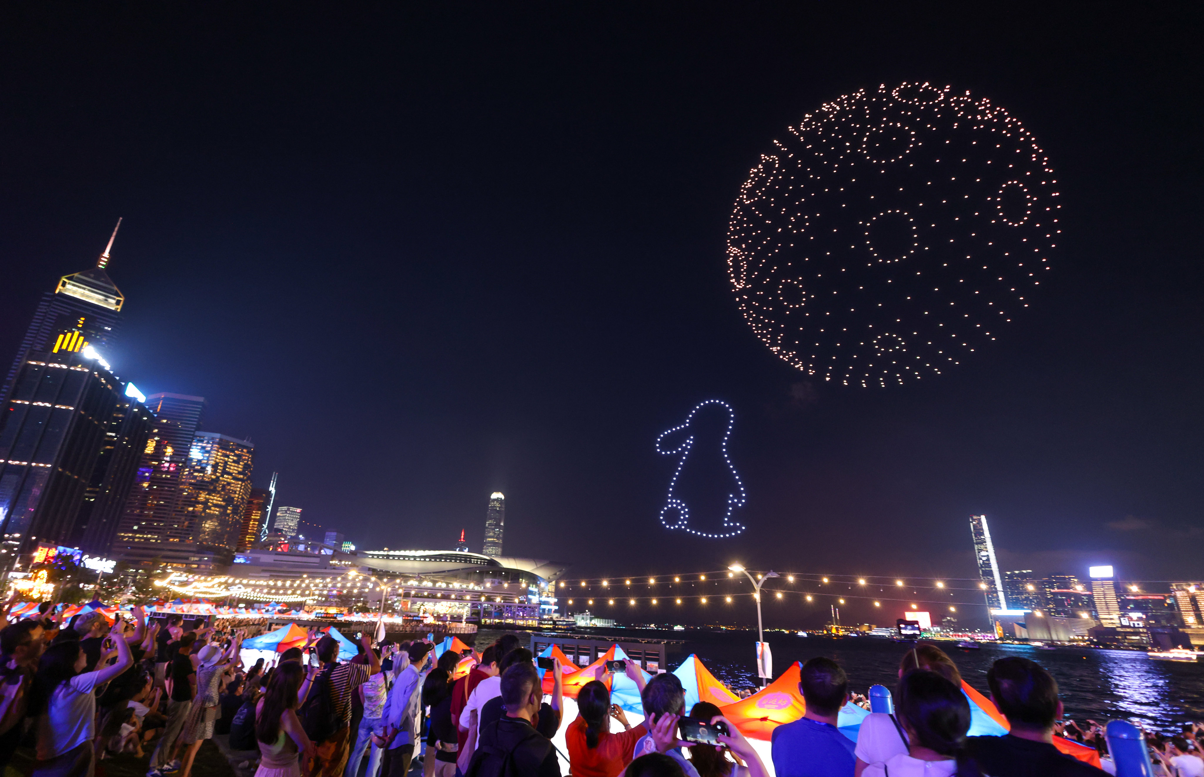 Revellers watch a light display created using drones as a part of the Waterfront Carnival at Wan Chai waterfront in Wan Chai. September 29, 2023. Photo: Yik Yeung-man