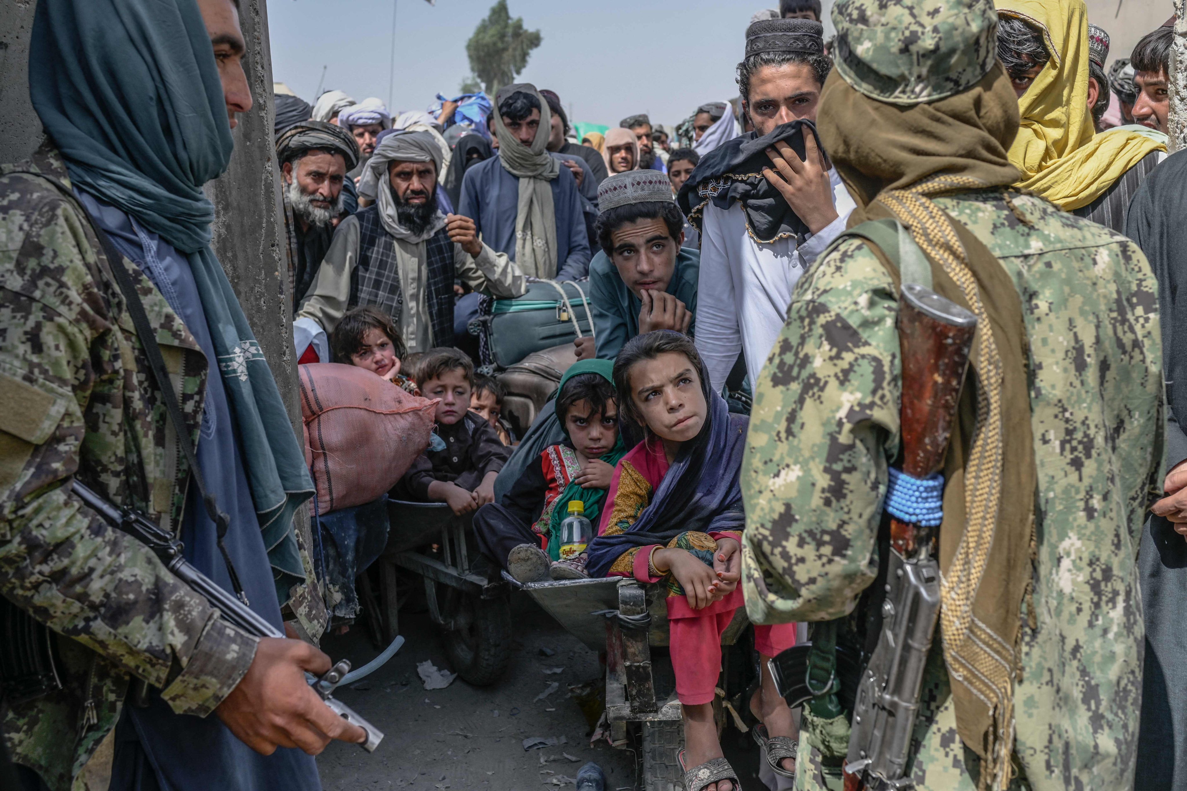 People wait as Taliban members stopped them rushing to pass to Pakistan from the Afghanistan border in September 2021. Photo: AFP