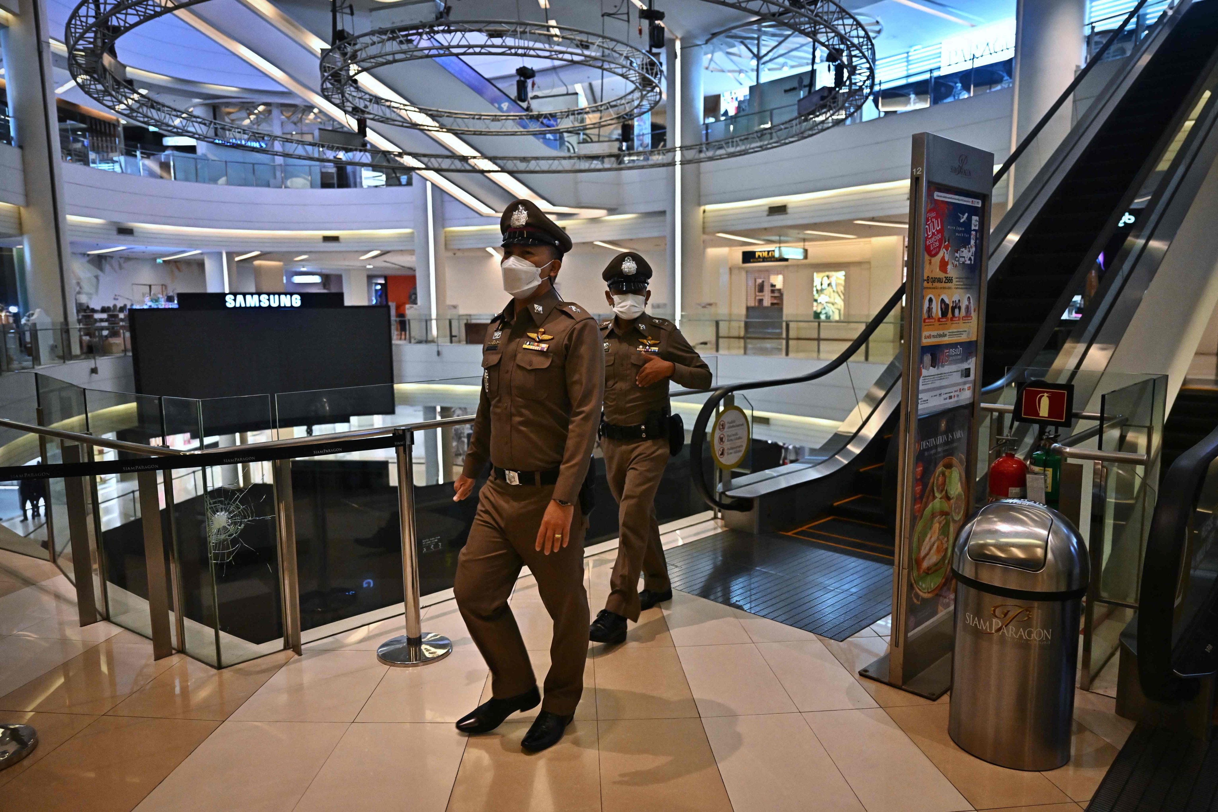 Thai police patrol inside the Siam Paragon shopping mall before opening in Bangkok on October 4, 2023. Photo: AFP