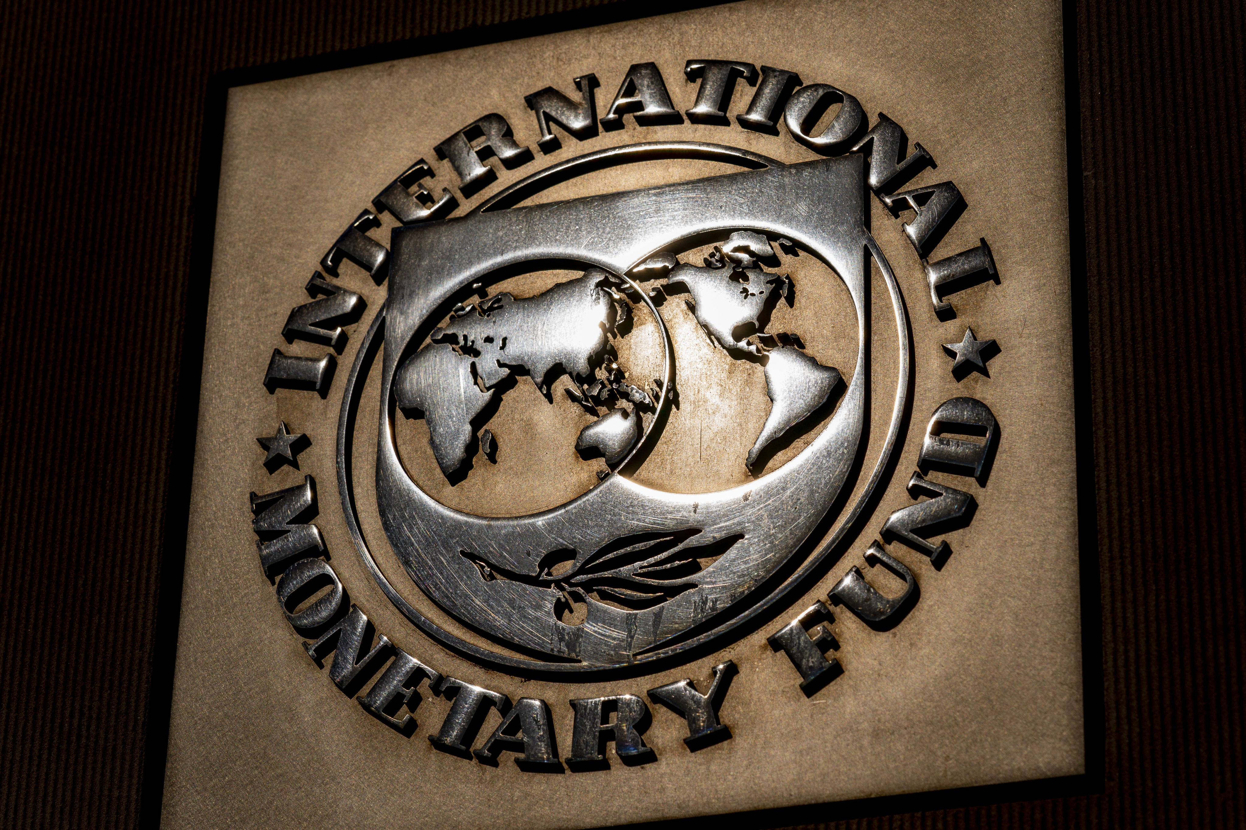 The logo of the International Monetary Fund is visible on its building, April 5, 2021, in Washington. The organisation has warned of further fragmentation of already strained commodity markets. Photo: AP