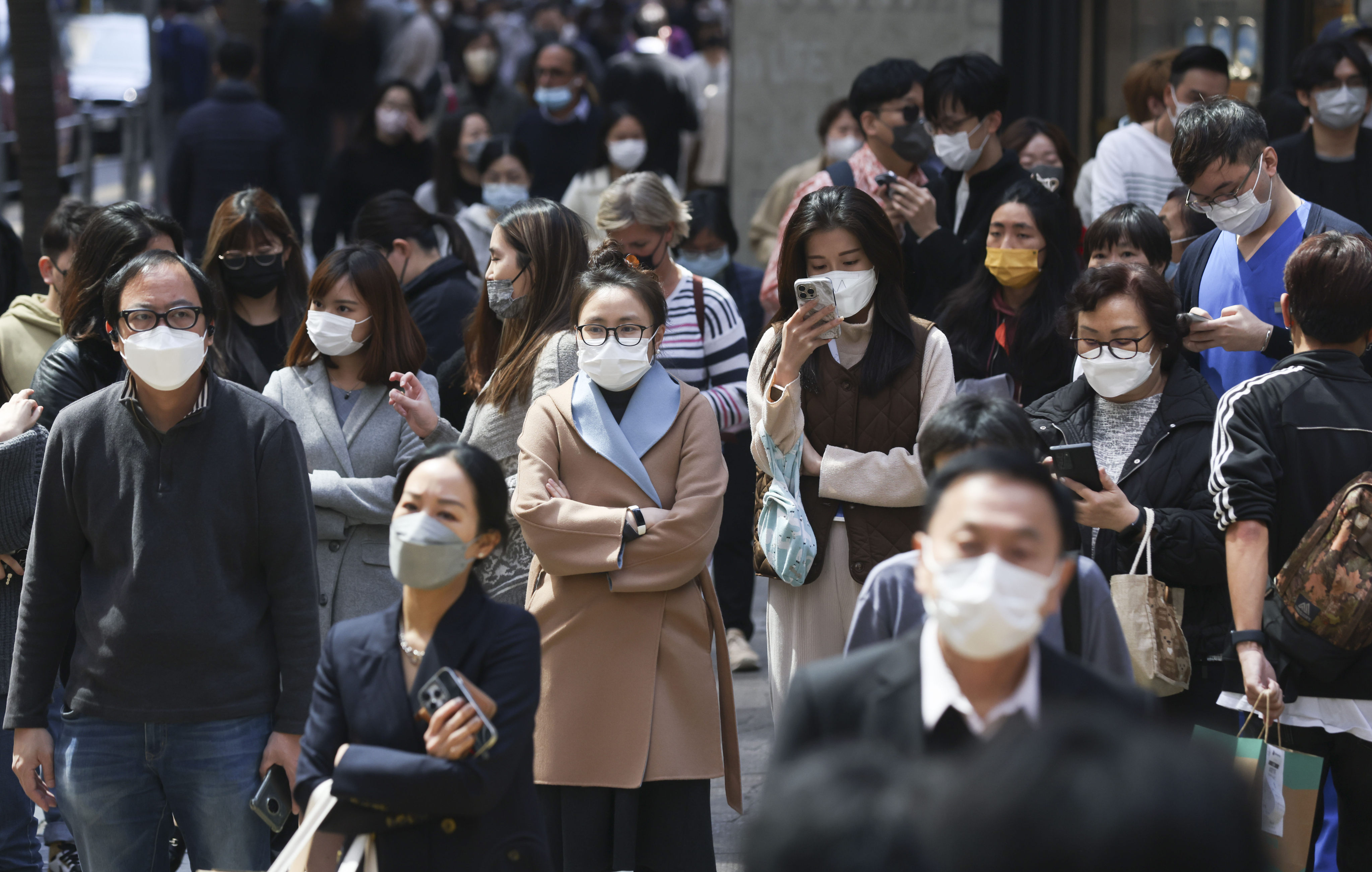 Commuters wear masks in Central, Hong Kong, on February 28, 2023. Cliff Buddle returned to the UK from Hong Kong in August 2022 and managed to survive over a year without catching Covid-19. Photo: May Tse