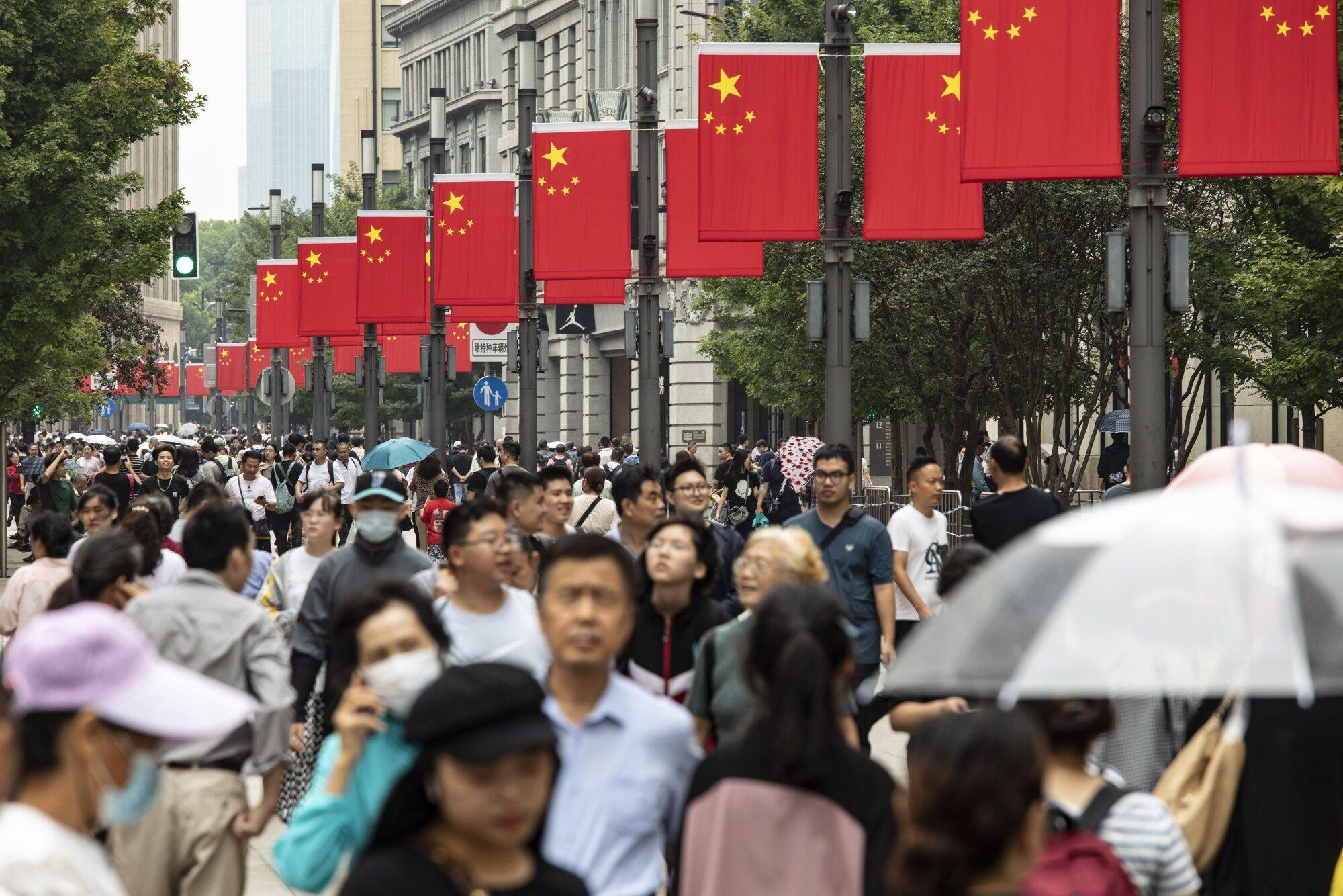 Visitors walk down the main shopping street of Nanjing East Road, one of the city’s main commercial and tourist areas, in Shanghai, China on September 30. China’s “golden week” holiday period has seen a boom in consumption and tourism. Photo: Bloomberg