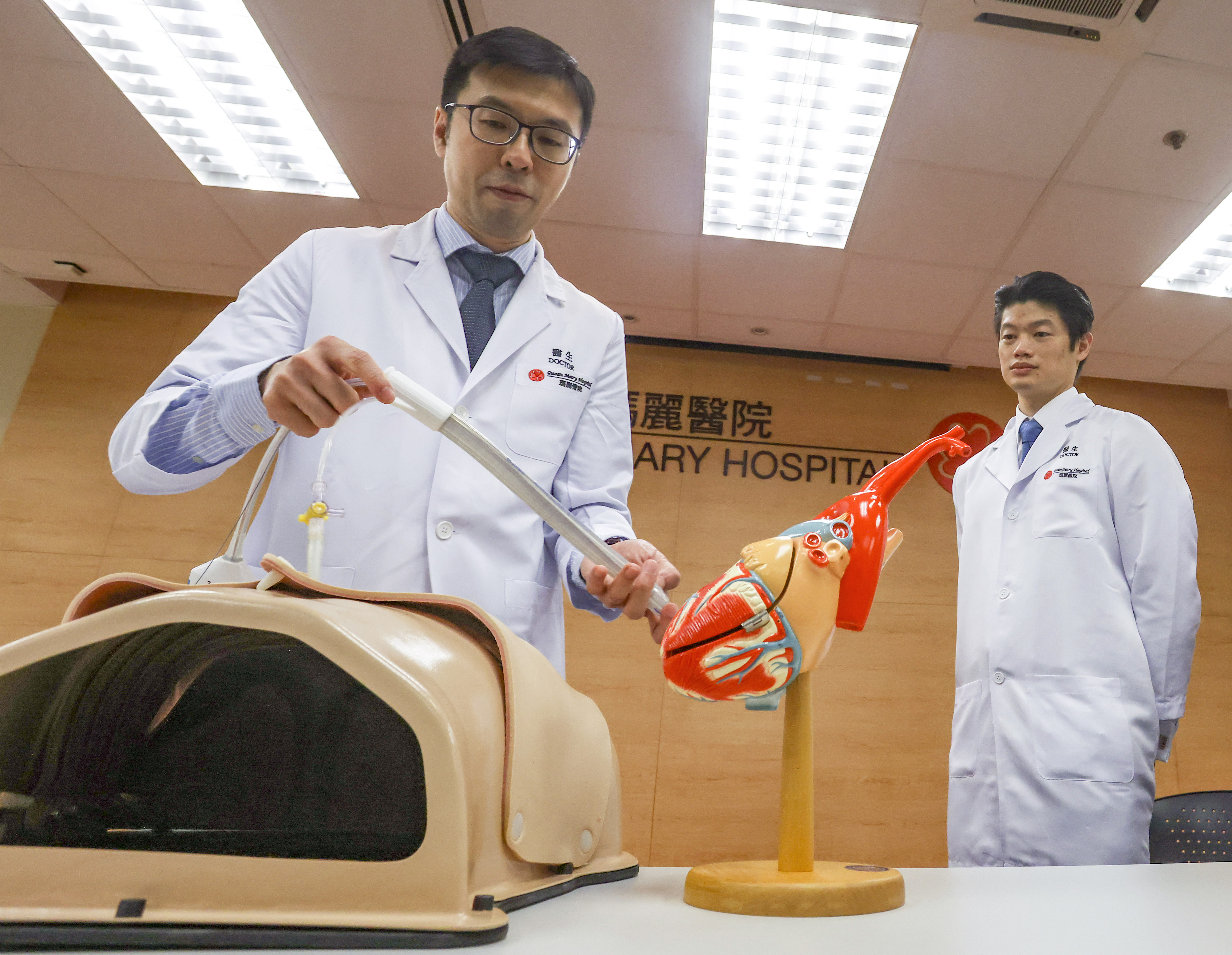 Dr Daniel Chan and Dr Max Wong demonstrate the new treatment for chronic irregular heartbeat at Queen Mary Hospital. Photo: Jonathan Wong