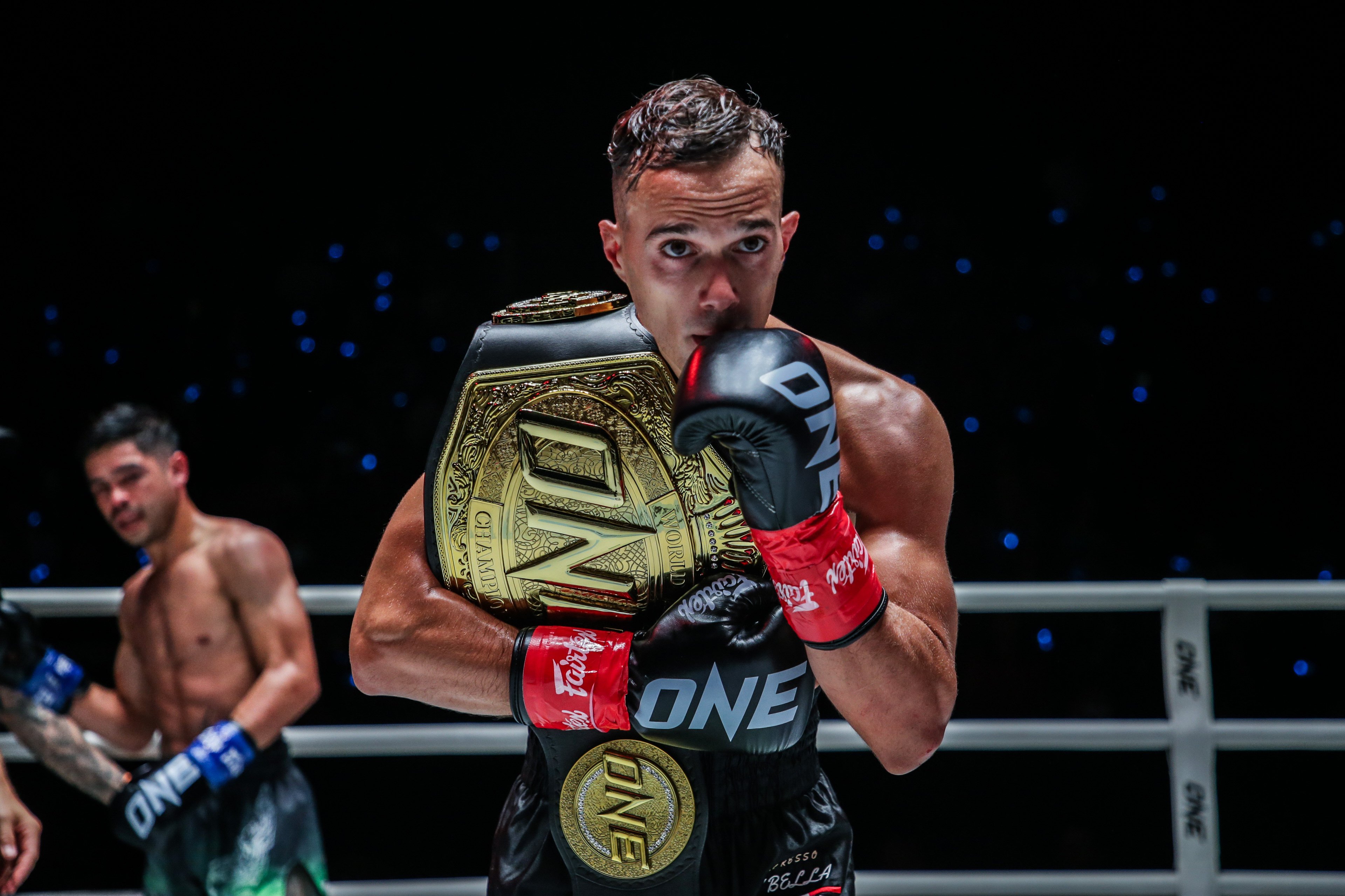 Jonathan Di Bella celebrates with his strawweight kickboxing title after beating Danial Williams at ONE Fight Night 15. Photo: ONE Championship