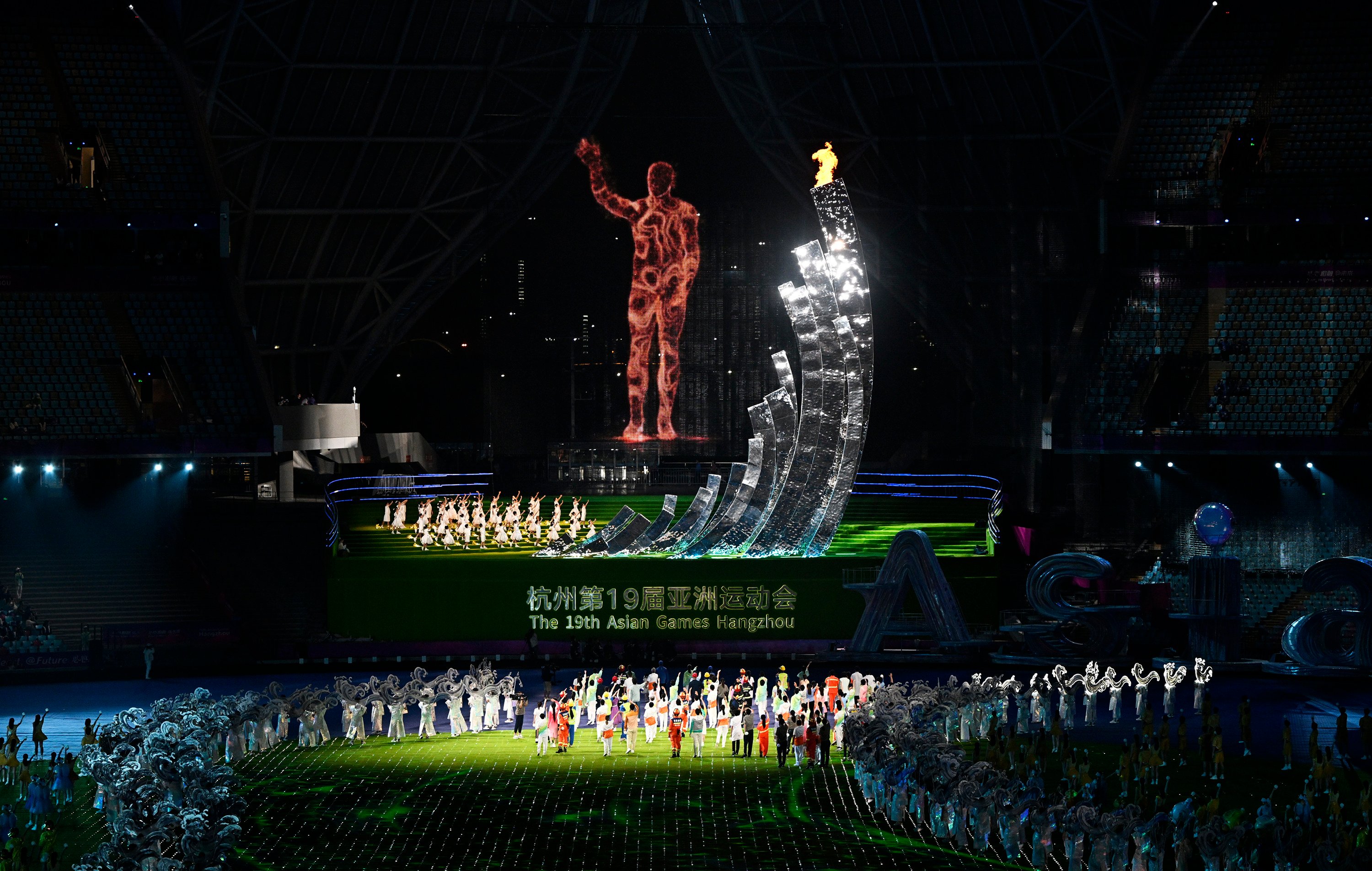The cauldron of the 19th Asian Games at the Hangzhou Olympic Sports Centre Stadium is extinguished by a giant digital torchbearer. Photo: Xinhua