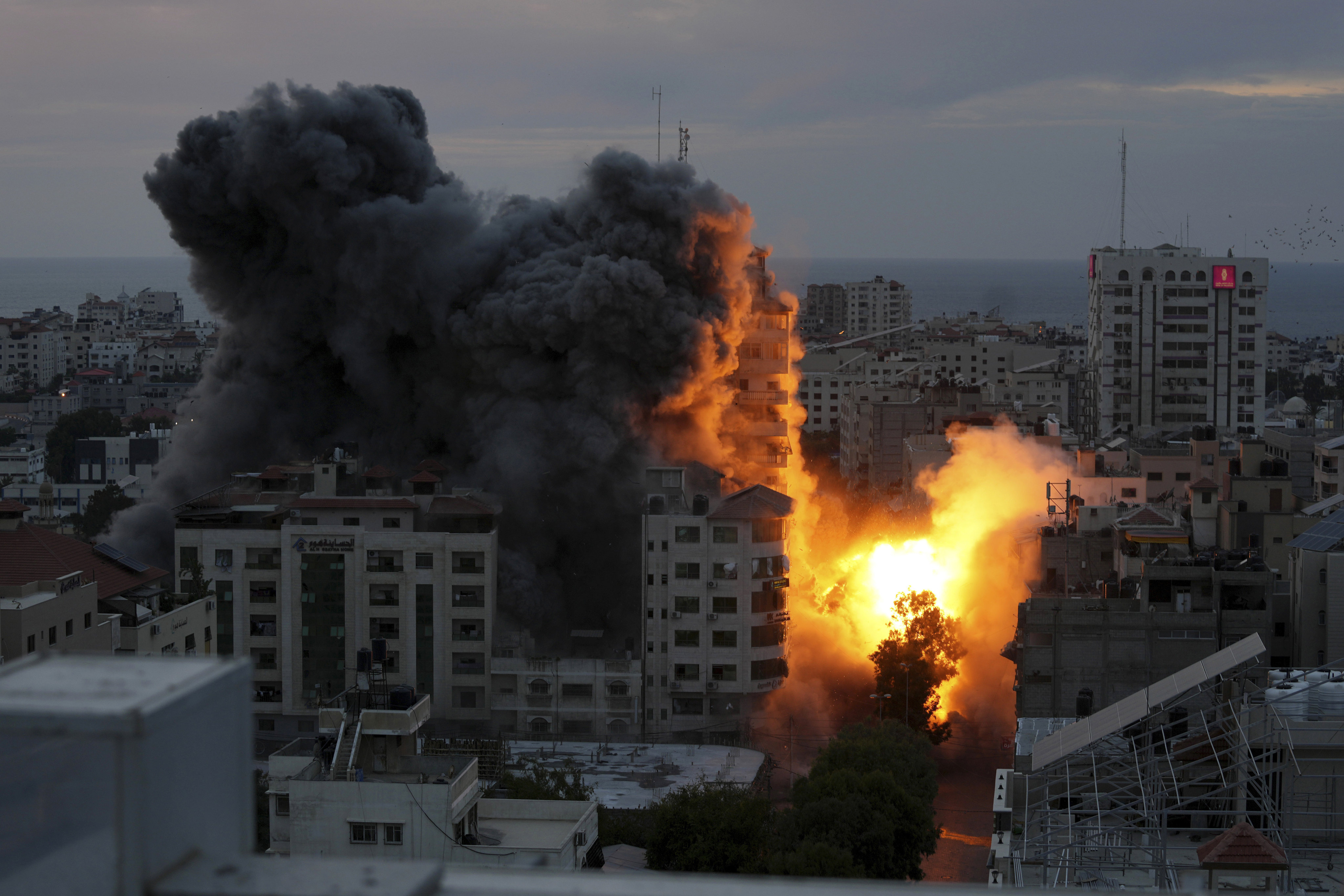 Fire and smoke rise from a a Palestinian apartment building following an Israeli air strike in Gaza City. Photo: AP