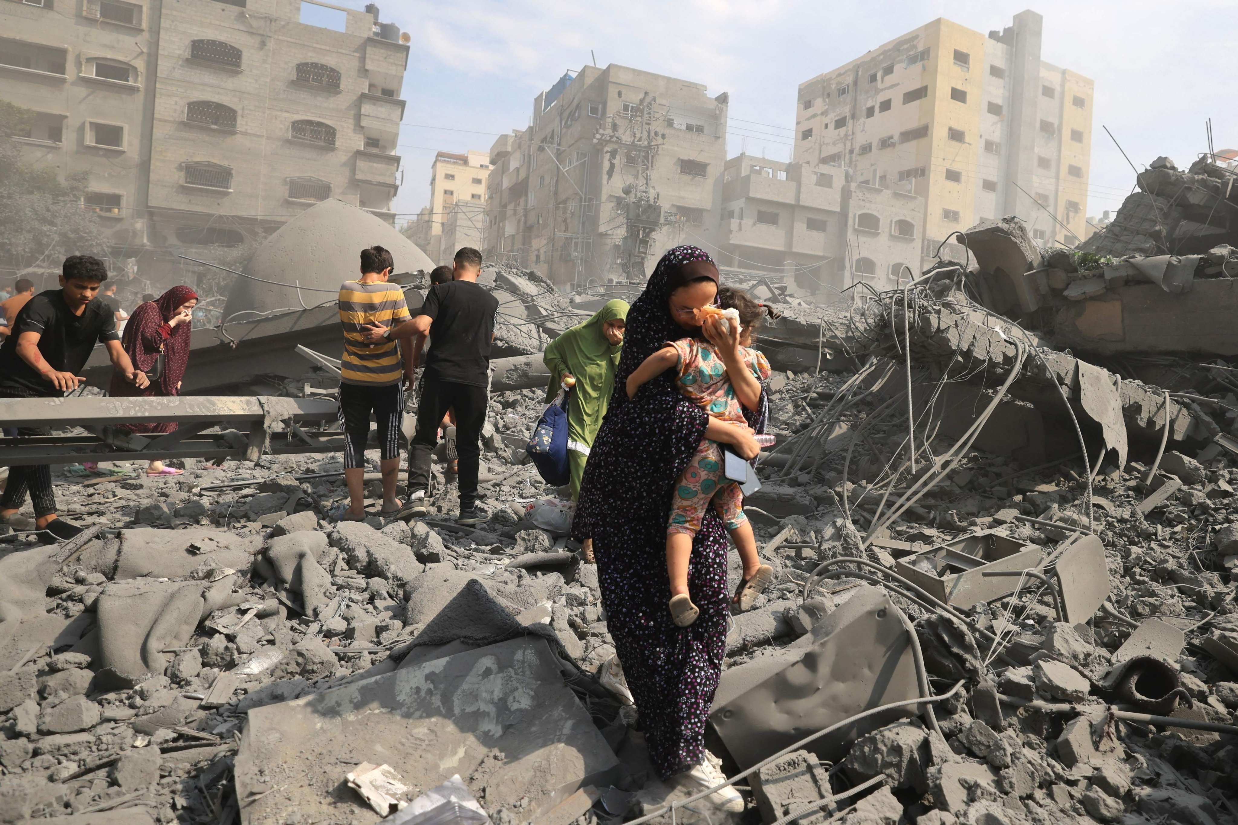 Palestinians evacuate the area following an Israeli airstrike on the Sousi mosque in Gaza City on October 9, 2023. Photo: AFP
