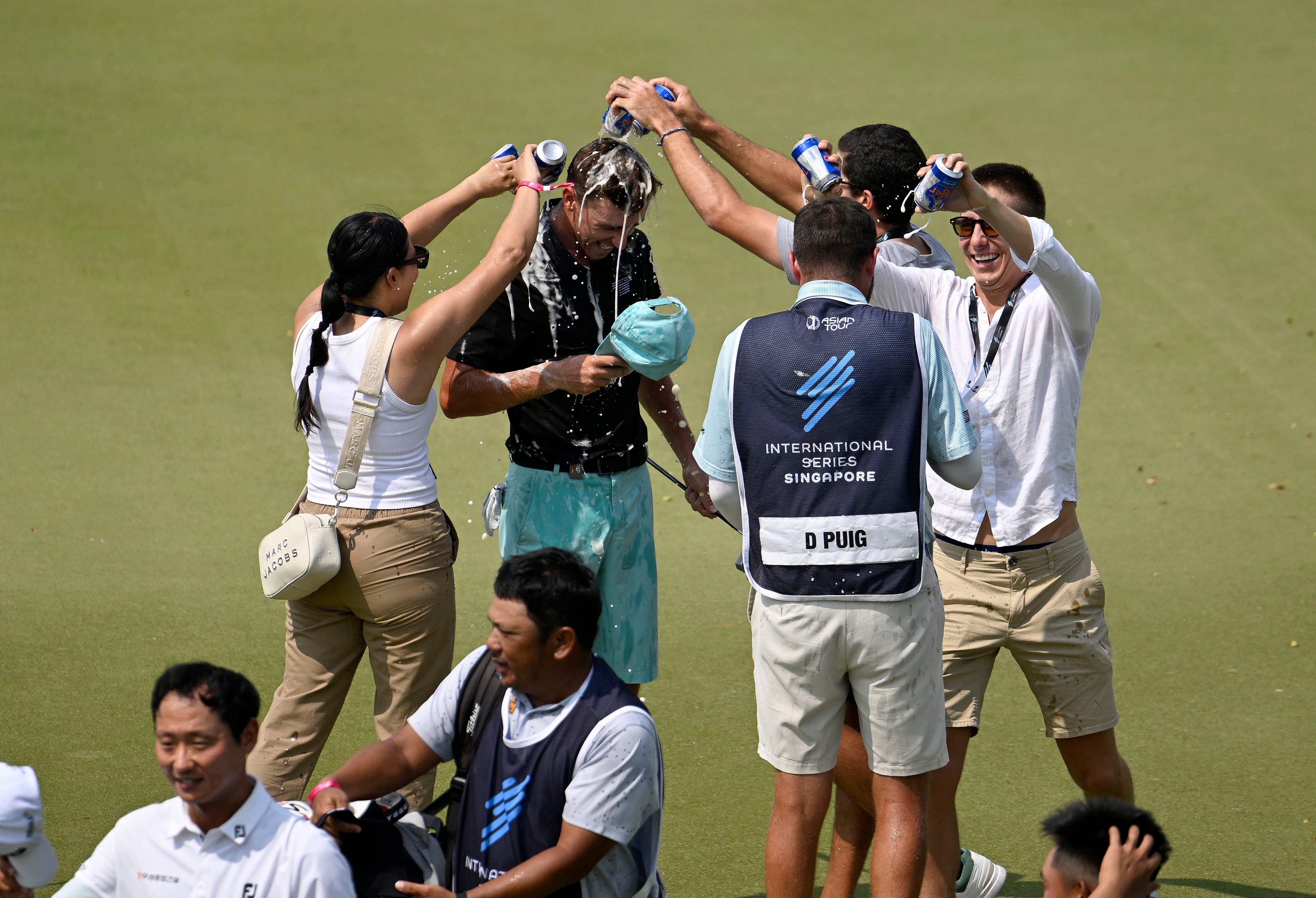 David Puig gets a soaking on the 18th green after winning the International Series Singapore at the Tanah Merah Country Club. Photo: Asian Tour
