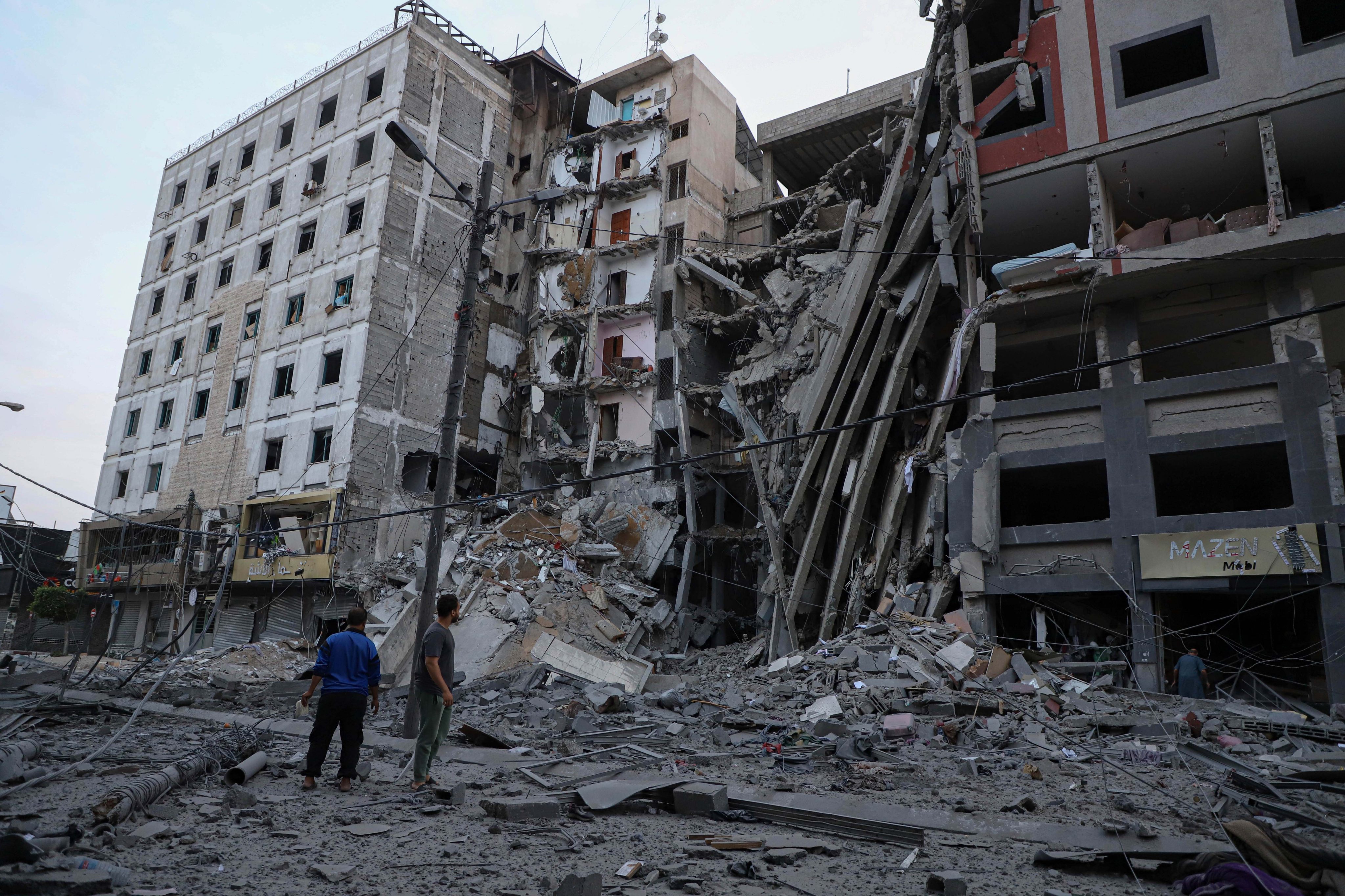 Palestinians check destroyed buildings following an Israeli airstrike in Gaza City on October 8. Israel’s cabinet declared a “state of war” on Sunday after a massive surprise attack launched by Hamas. Photo: Xinhua