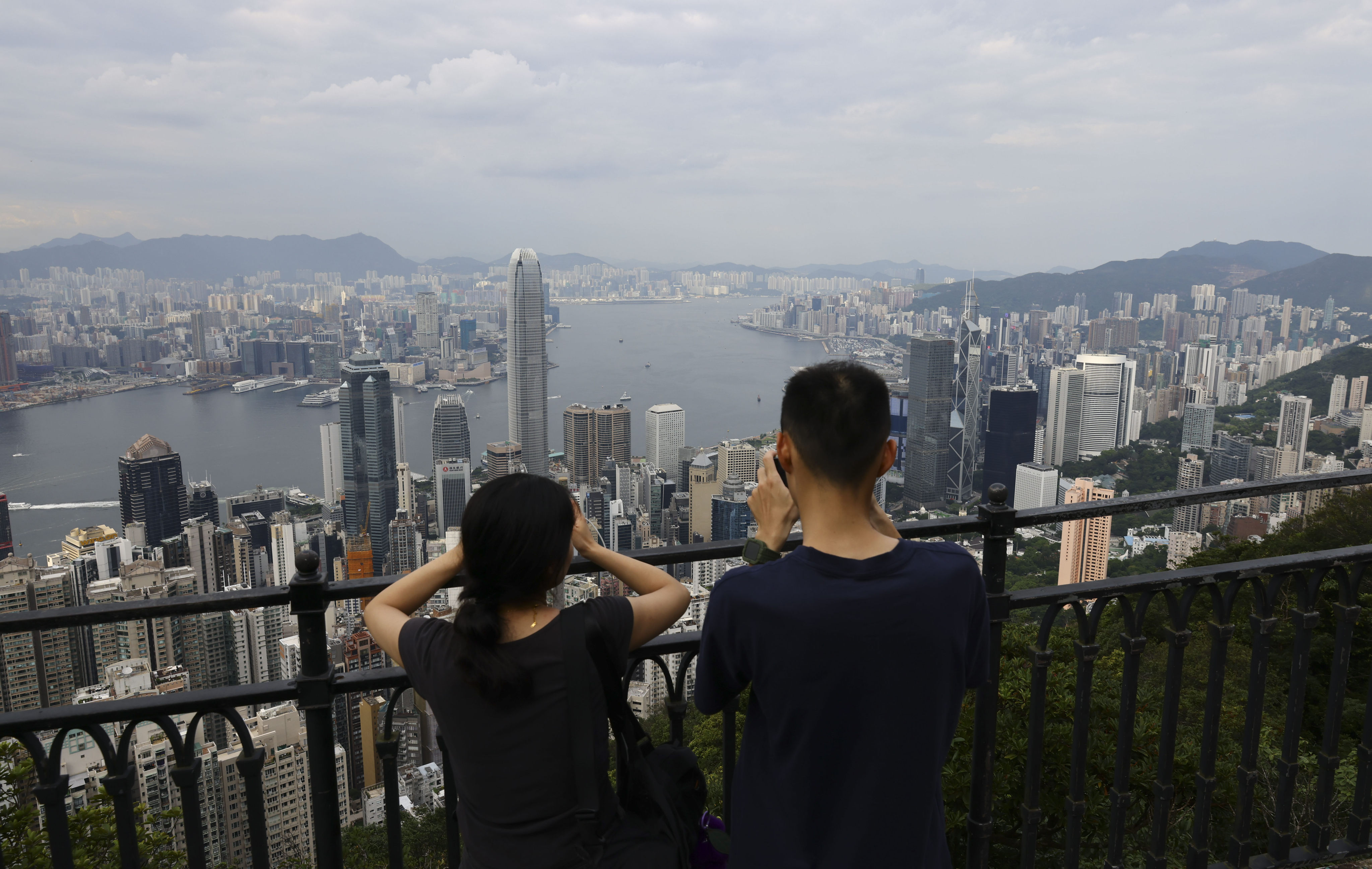 Tourists take photographs of the Hong Kong skyline from the Peak on July 27. Photo: Dickson Lee