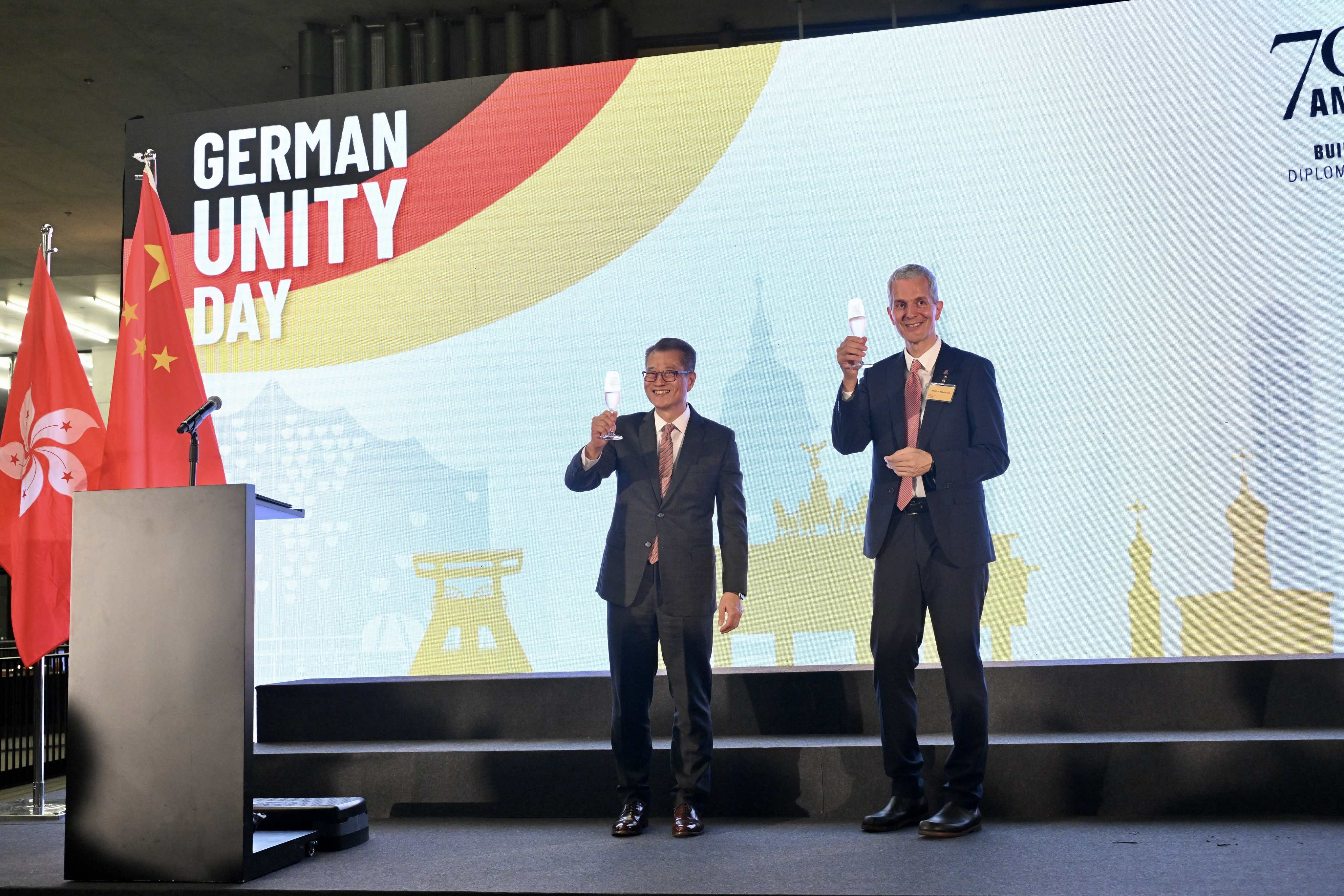 (From left) Financial Secretary Paul Chan and German consul general Stefan Bredohl toast German reunification and the anniversaries of three of its organisations in the city. Photo: Handout