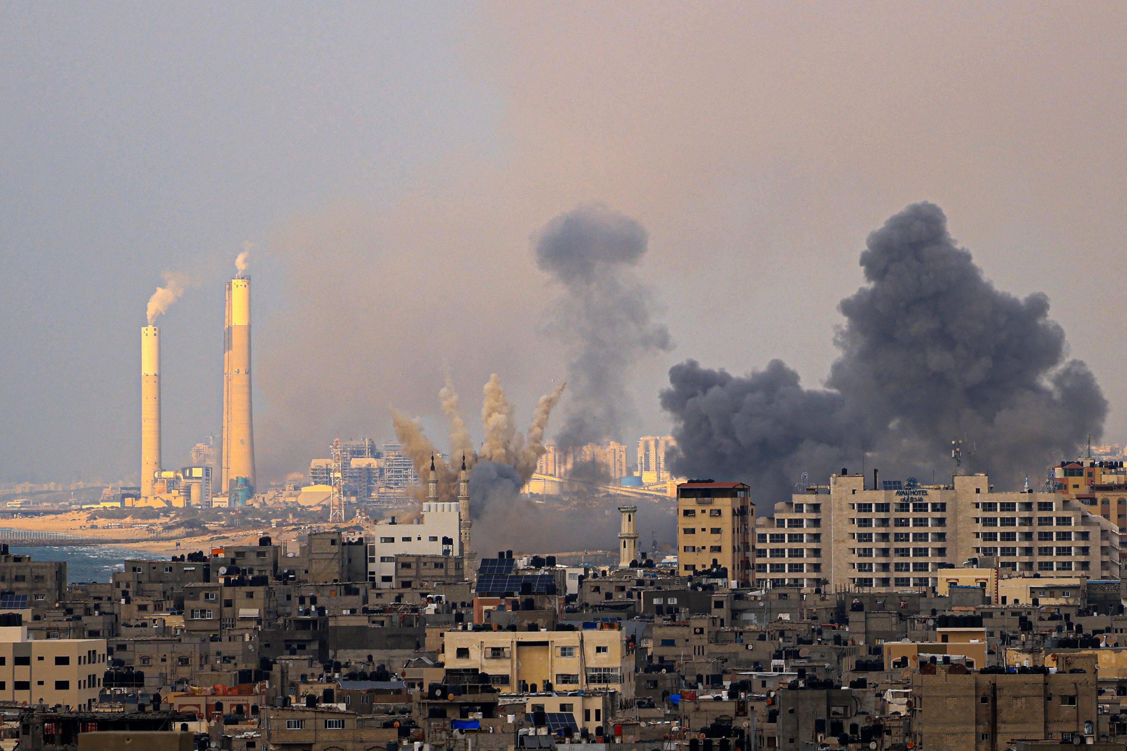 Smoke billows behind highrise buildings in Gaza City during Israeli air strikes on Wednesday. Photo: AFP