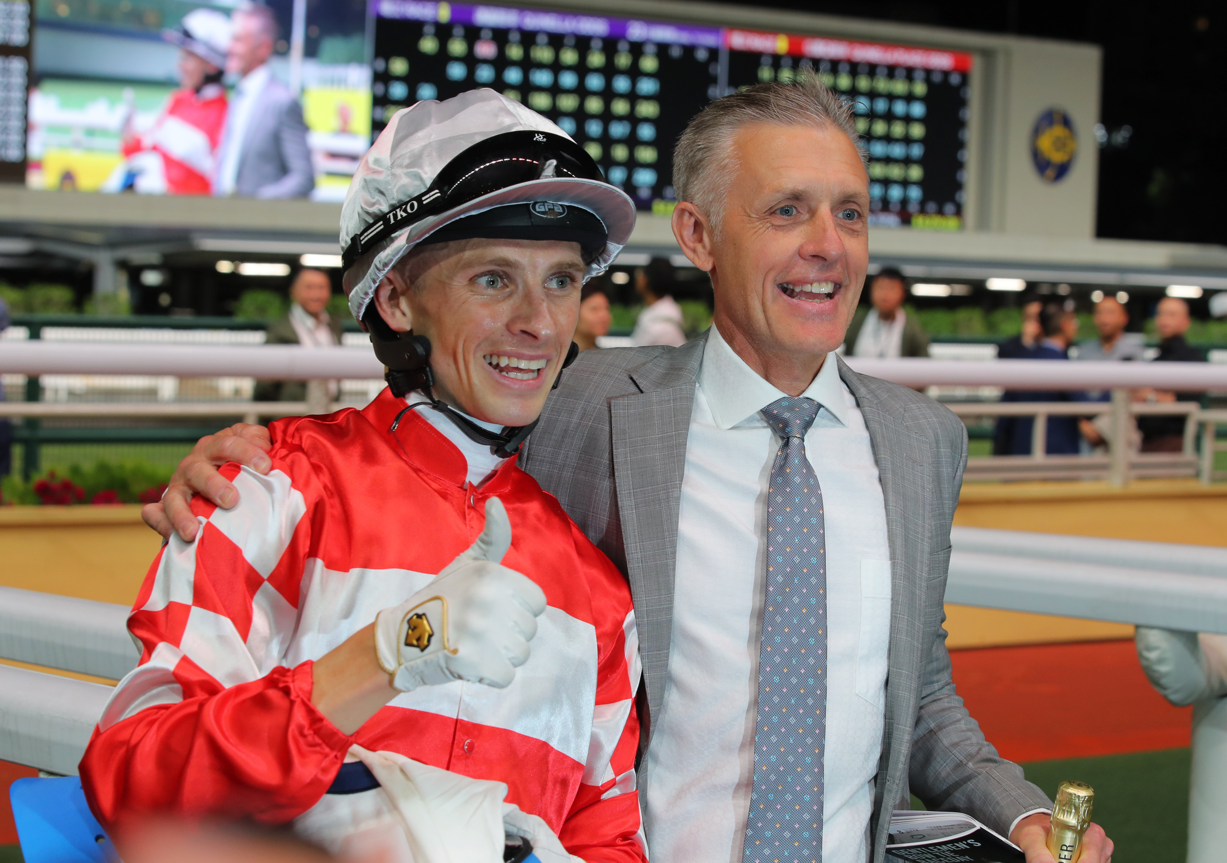 A beaming Mark Newnham celebrates his first Hong Kong win with jockey Lyle Hewitson. Photo: Kenneth Chan