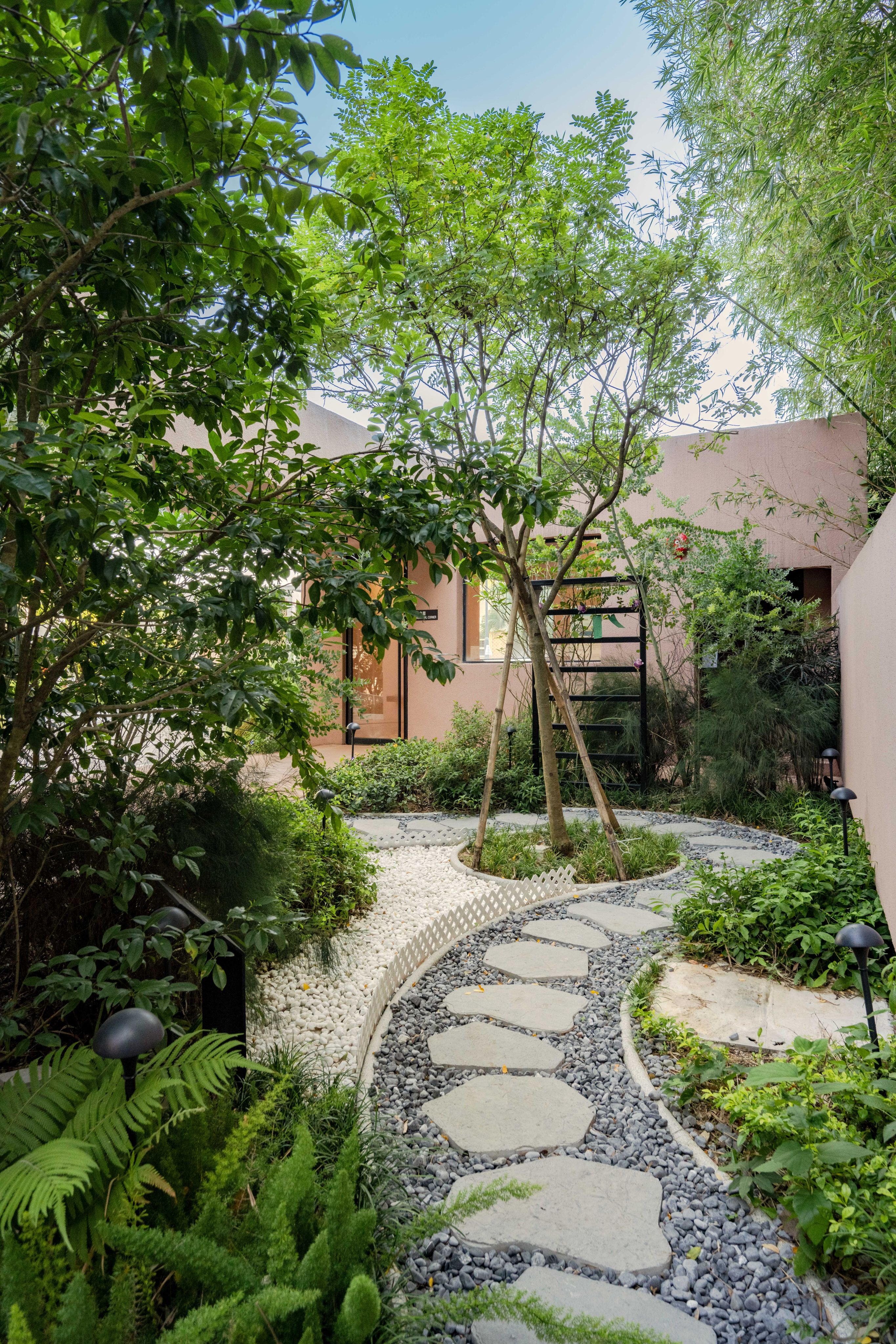 Visitors to the Home of Forever Love in Hong Kong circumnavigate the leafy plot partly on paving stones that curve around a crepe myrtle feature tree. The crematorium’s design reflects how architecture can be used to affect emotions. Photo: Eugene Chan