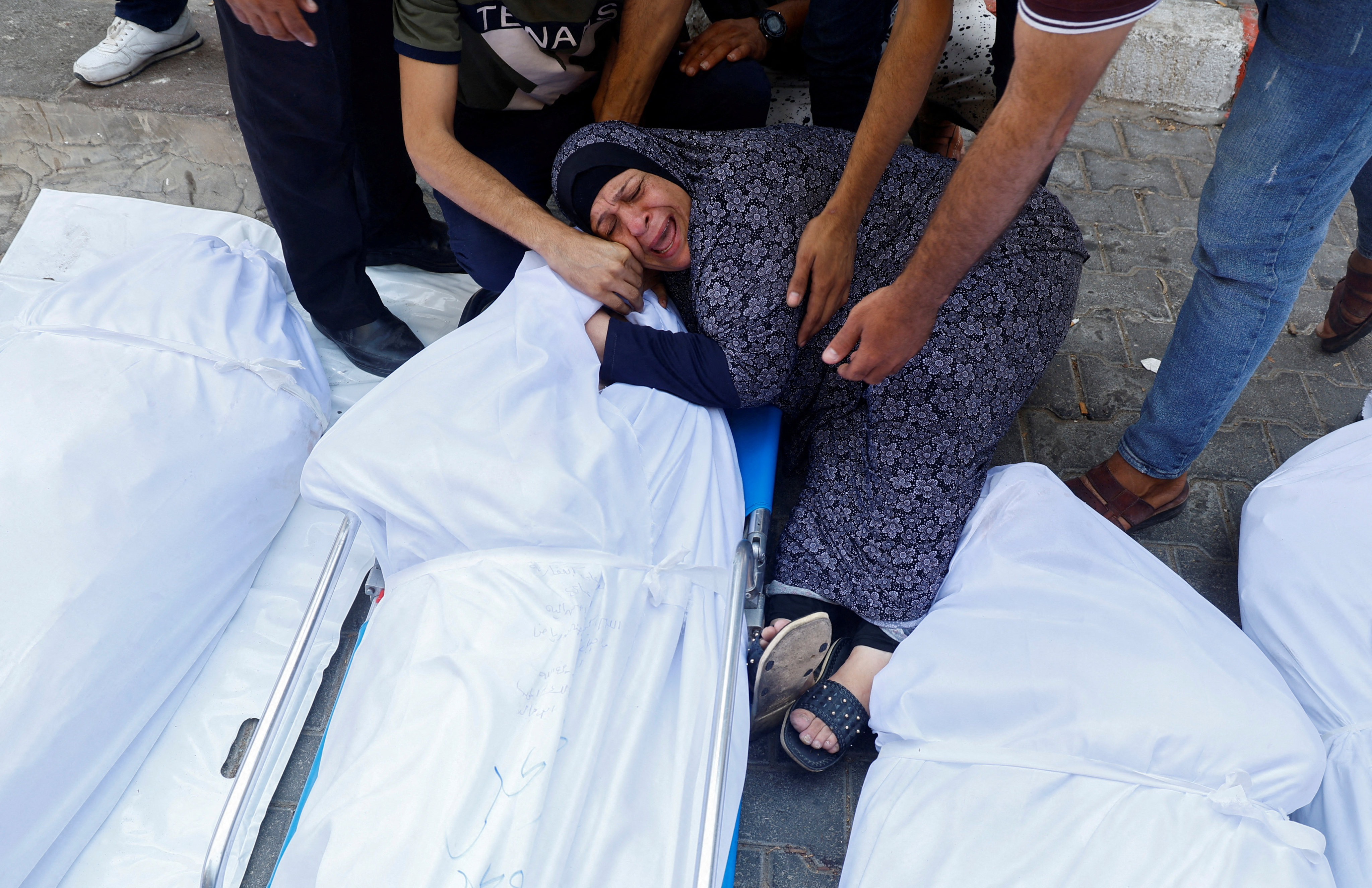 A relative reacts next to the bodies of Palestinians killed in Israeli strikes, at a hospital in Gaza City. Photo: Reuters