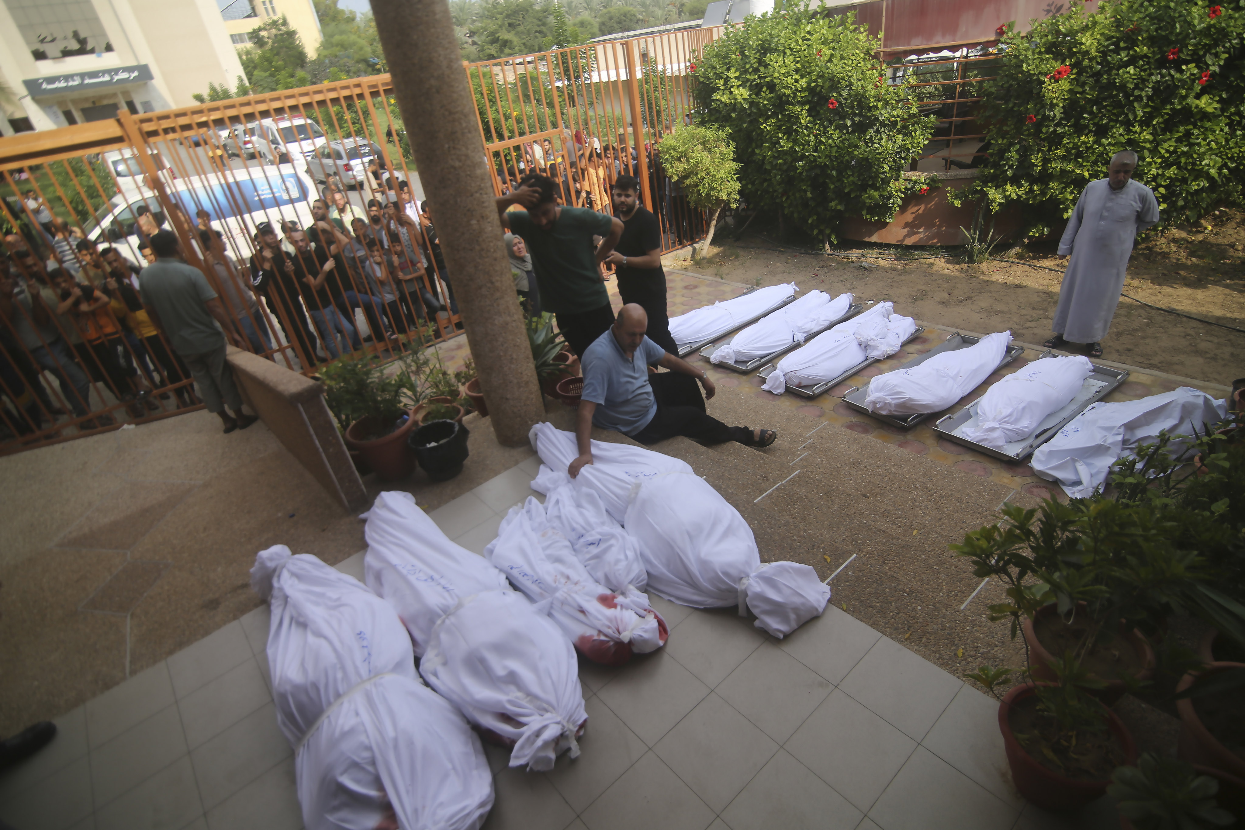 Palestinians gather around the bodies of people killed in Israeli airstrikes on the Gaza Strip on Wednesday. Photo: AP