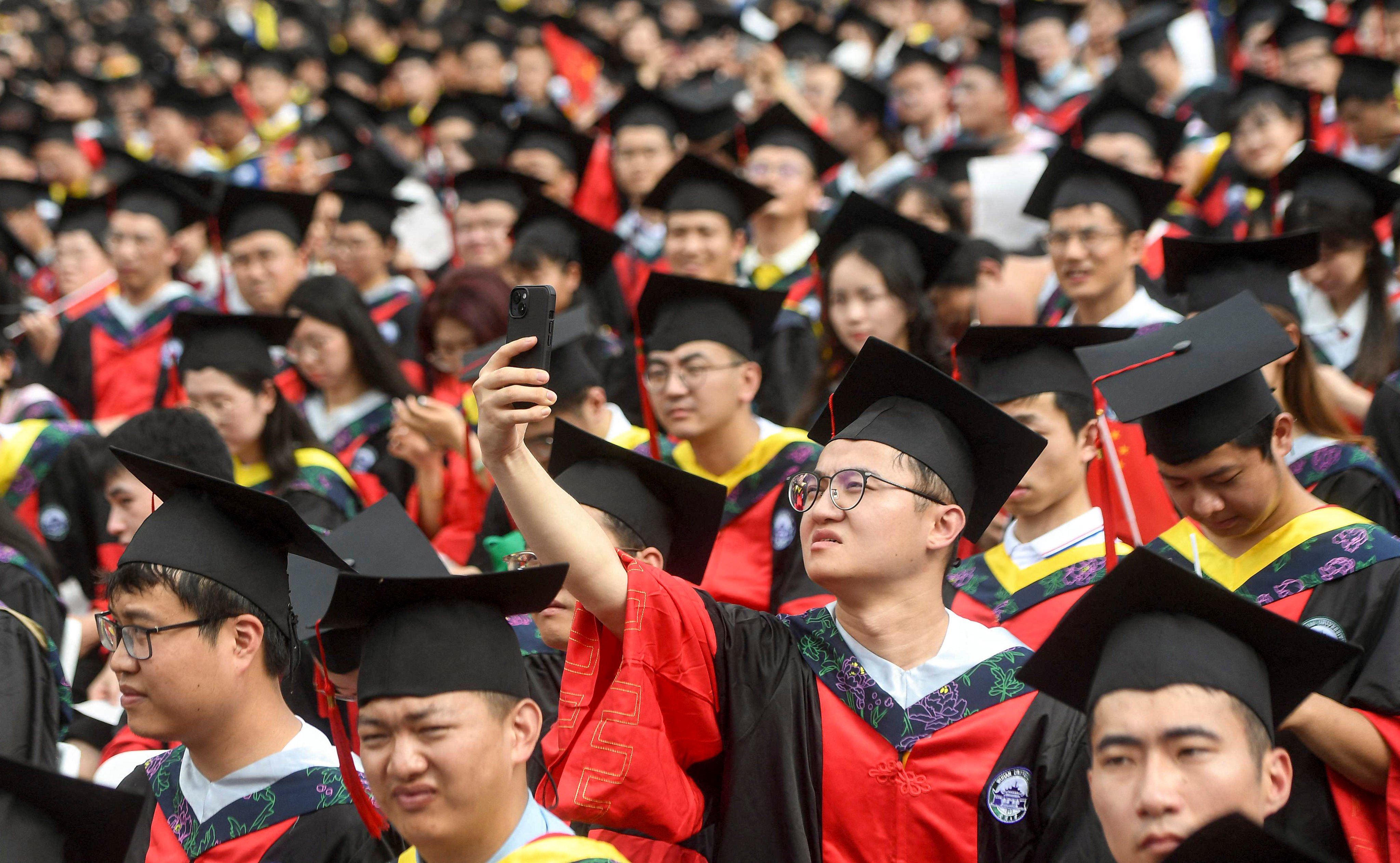 Students at China’s Wuhan University attend a graduation ceremony in June. Photo: AFP
