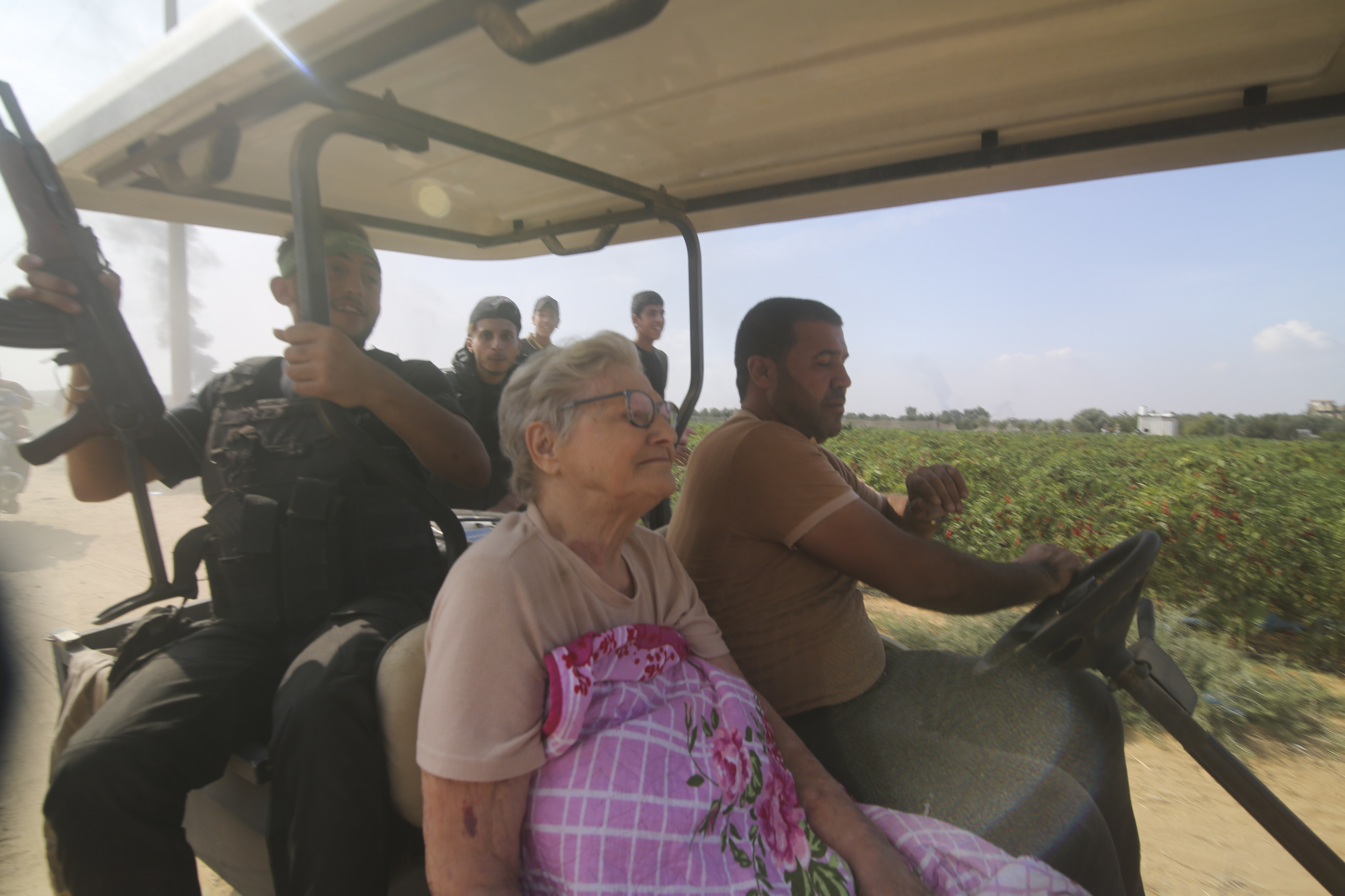 Palestinians transport captured Israeli civilian, 85-year-old Yaffa Adar, after Hamas carried out an unprecedented, multi-front attack on Israel on Saturday. Photo: AP