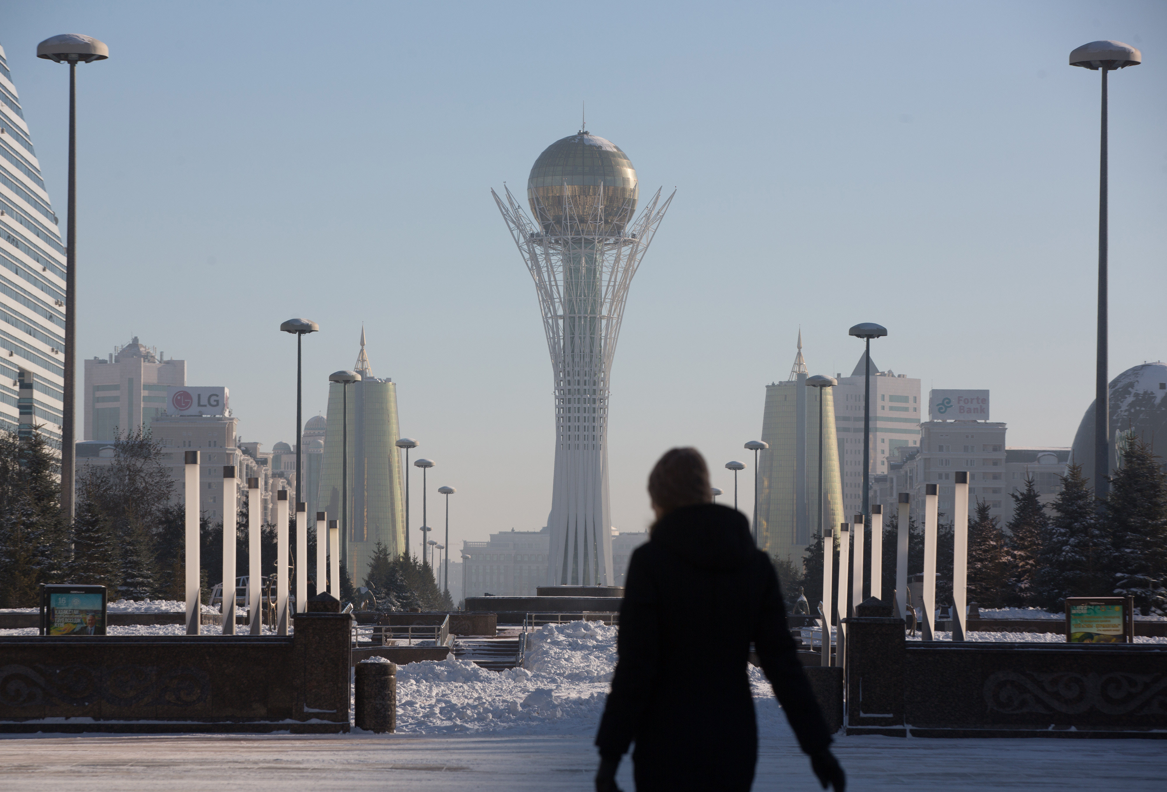 The Bayterek tower monument is flanked by the golden twin towers of Ministries House in Astana. Kazakhstan’s economic growth, propelled by oil and gas, has slowed in part from fluctuations in global commodity prices. Photo: Bloomberg